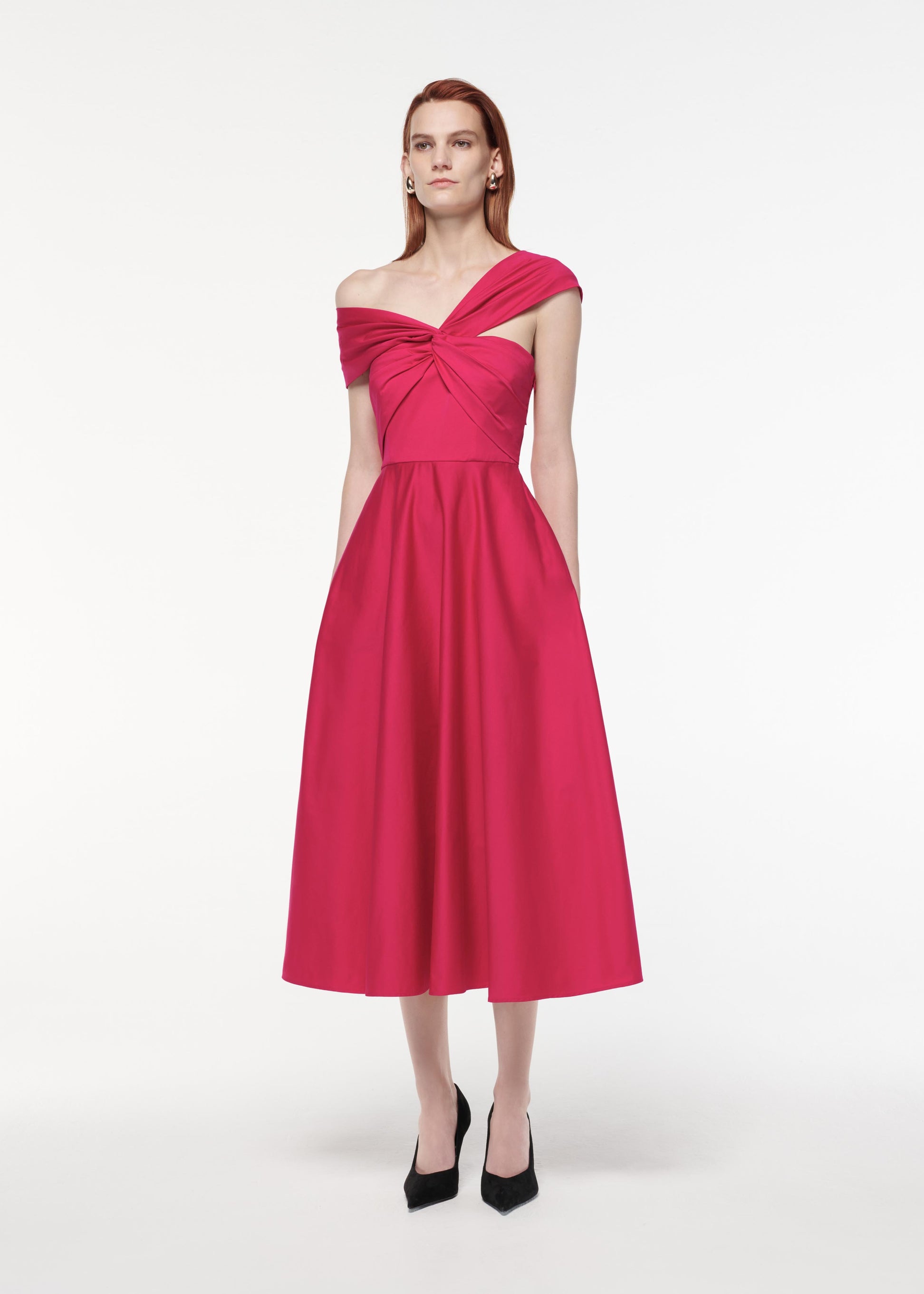 A photograph of a woman wearing a Asymmetric Stretch Cotton Poplin Midi Dress in Pink