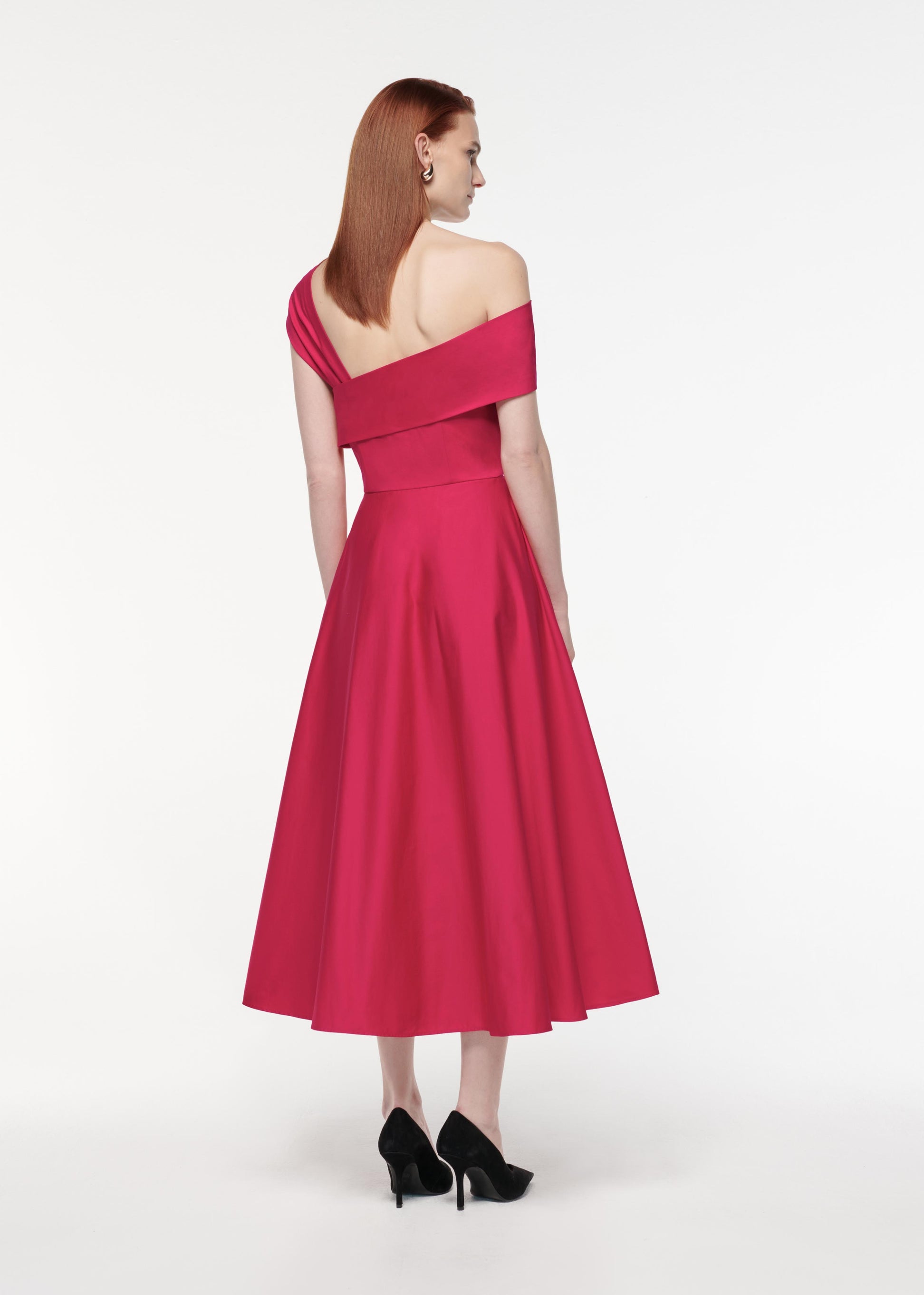 A photograph of a woman wearing a Asymmetric Stretch Cotton Poplin Midi Dress in Pink