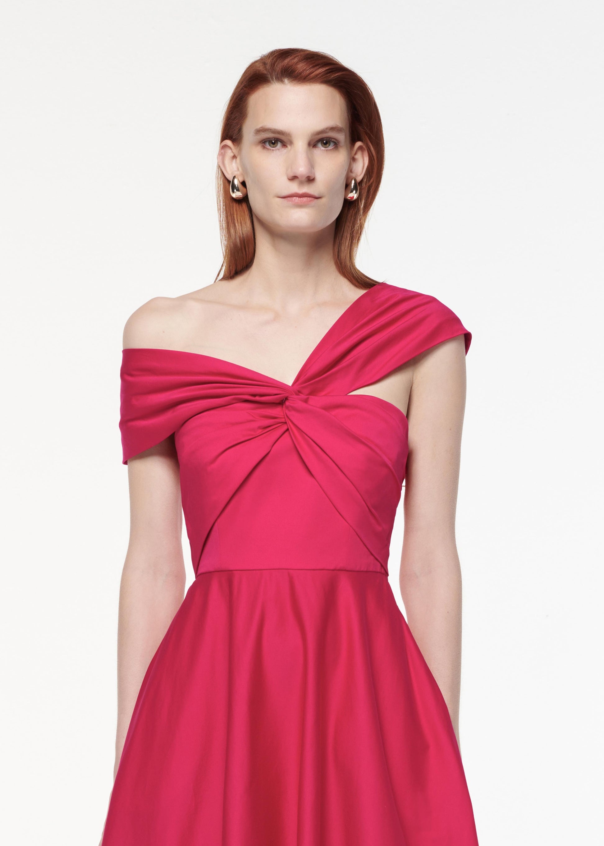 A photograph of a woman wearing a Asymmetric Stretch Cotton Poplin Midi Dress in Pink