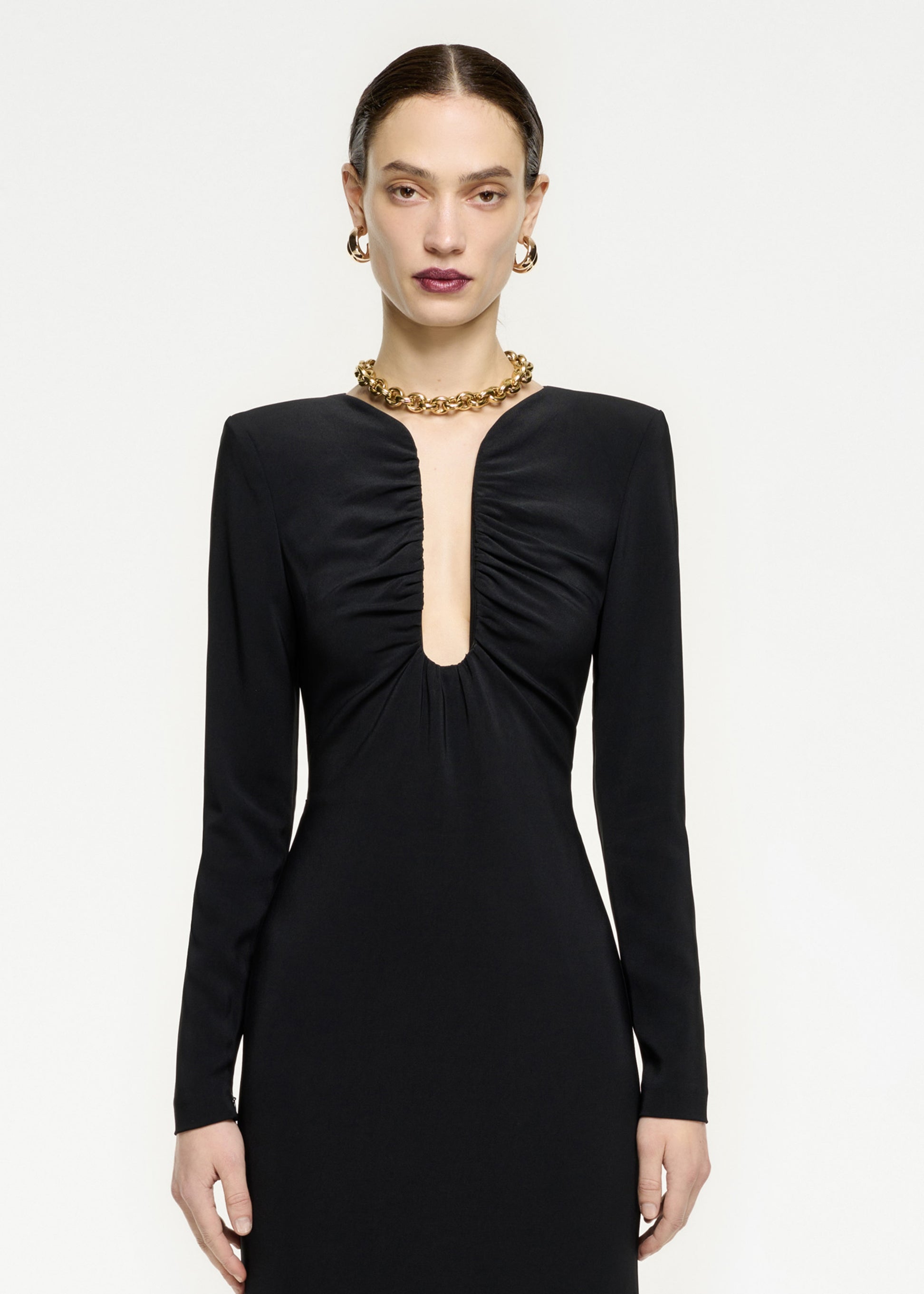 A close up of a woman wearing the Long Sleeve Stretch Cady Midi Dress in Black