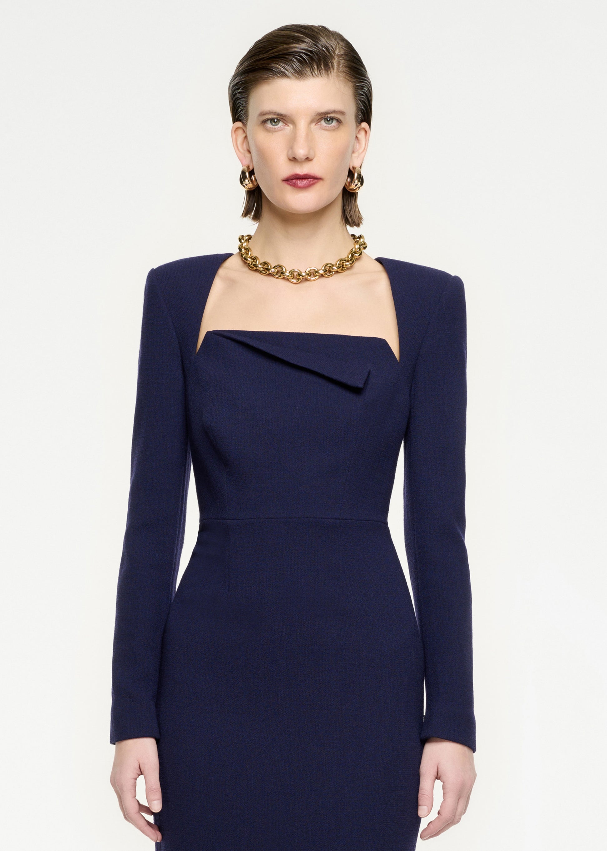 A close up of a woman wearing the Long Sleeve Wool Crepe Midi Dress in Navy