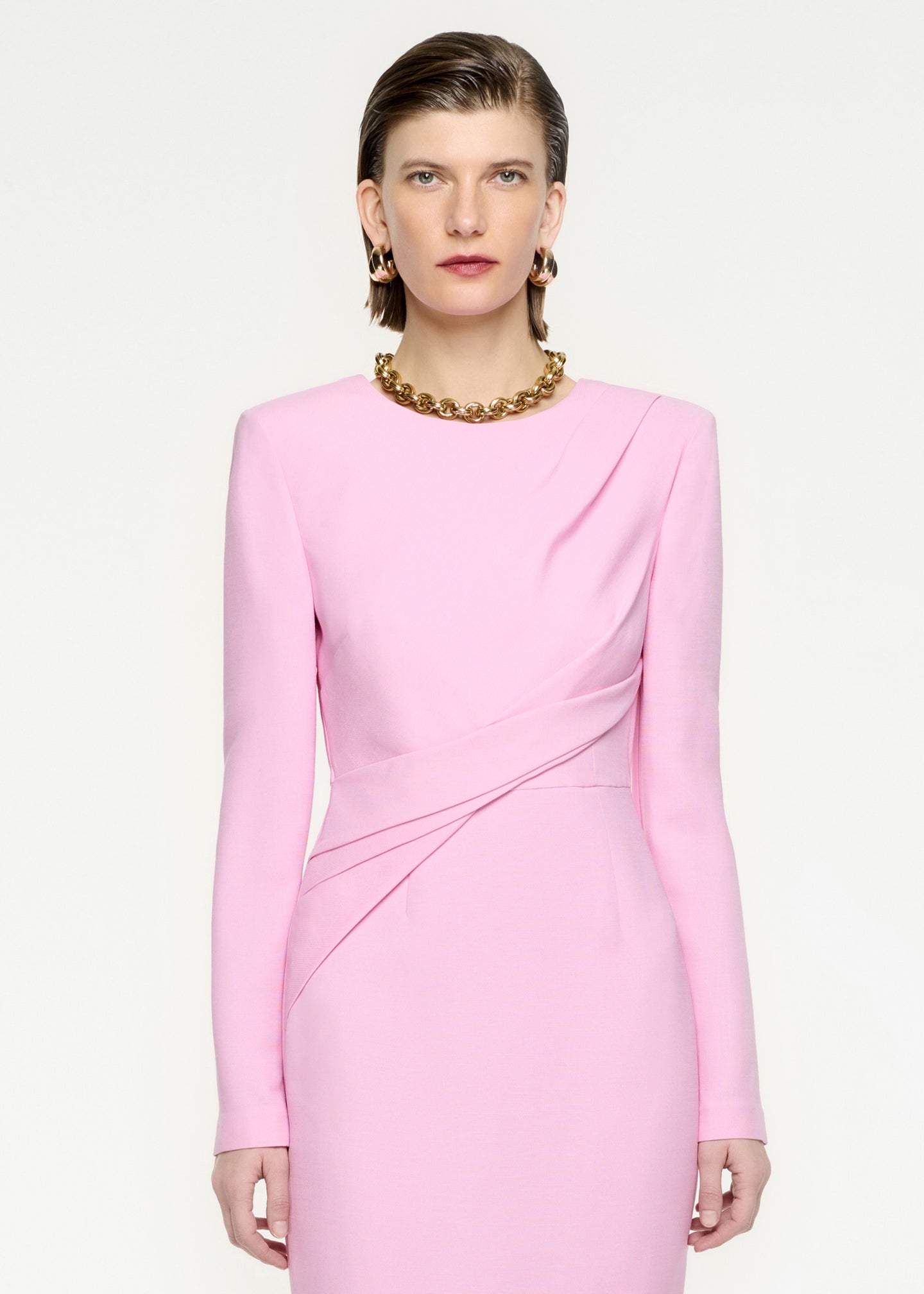 A close up of a woman wearing the Long Sleeve Wool Silk Midi Dress in Pink