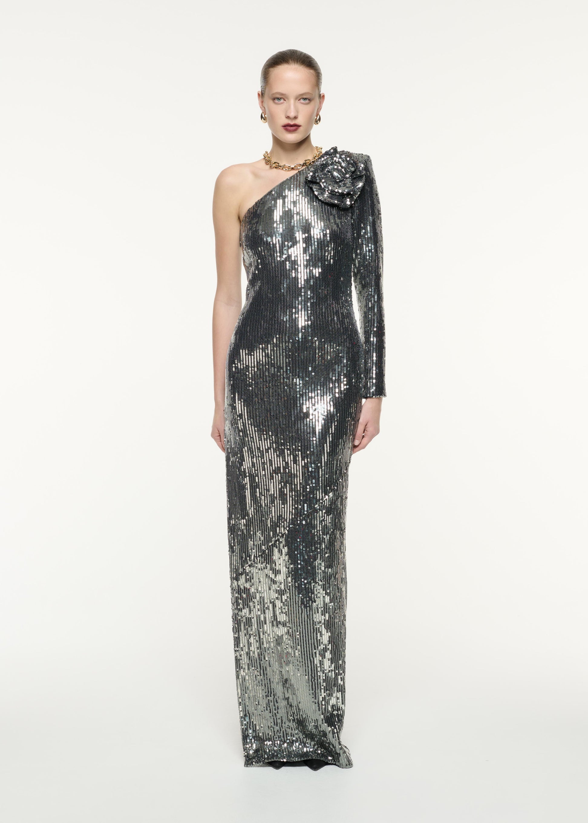 A front view image of a model wearing the Asymmetric Sequin Flower Gown in Green