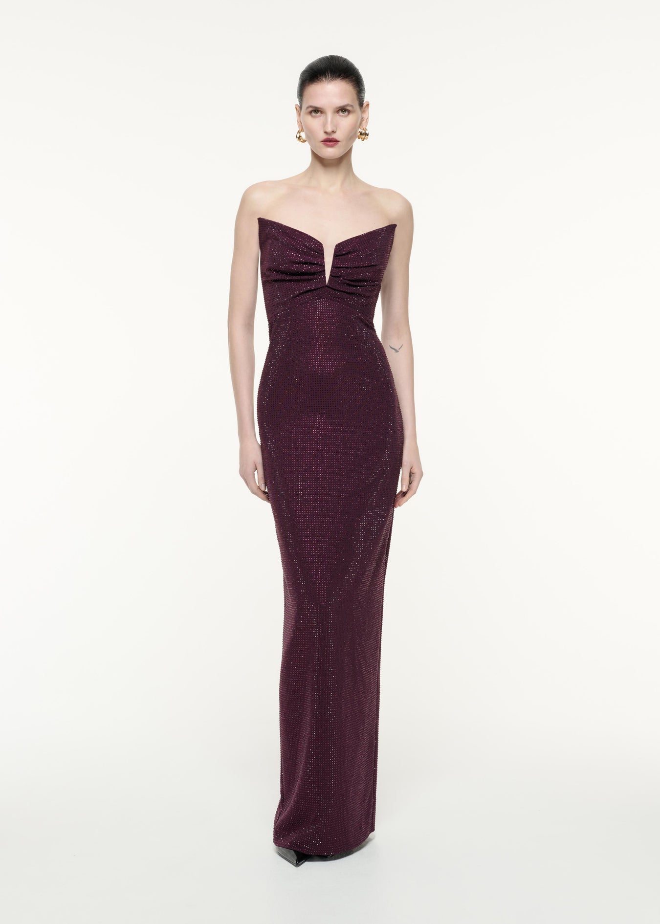 A front view image of a model wearing the Strapless Diamante Gown in Aubergine