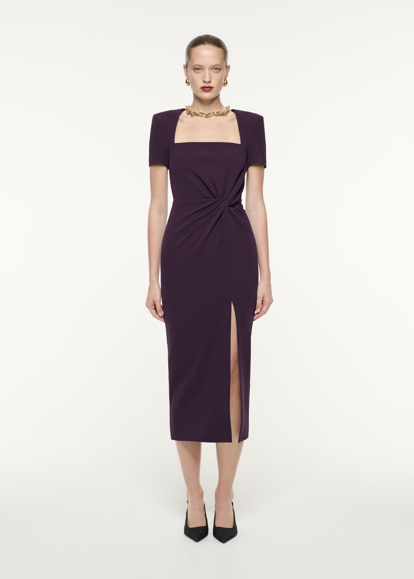 A front view image of a model wearing the Short Sleeve Heavy Cady Midi Dress in Aubergine