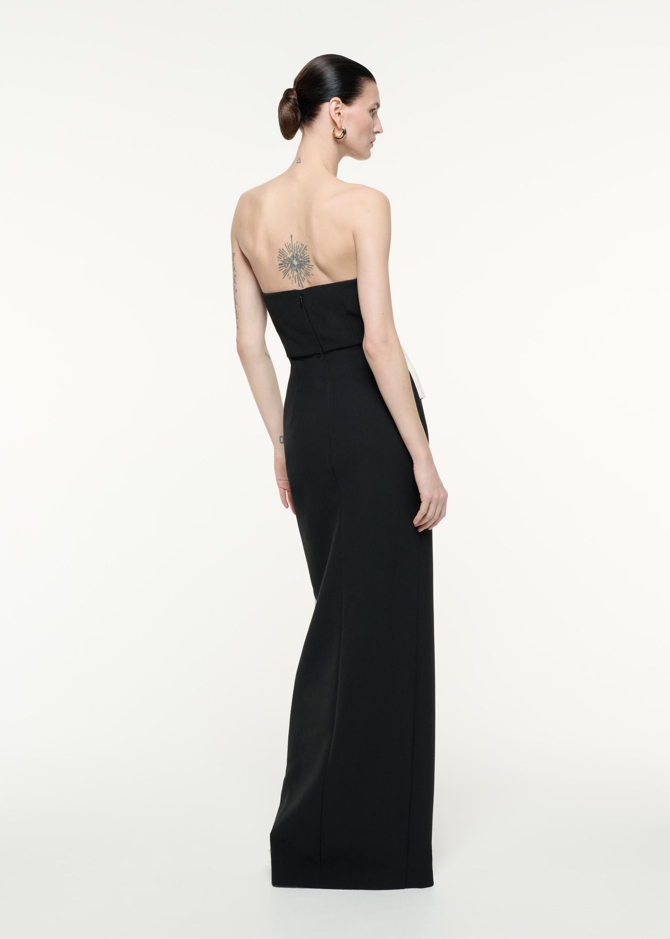 A back view image of a model wearing the Strapless Crepe Gown in Monochrome