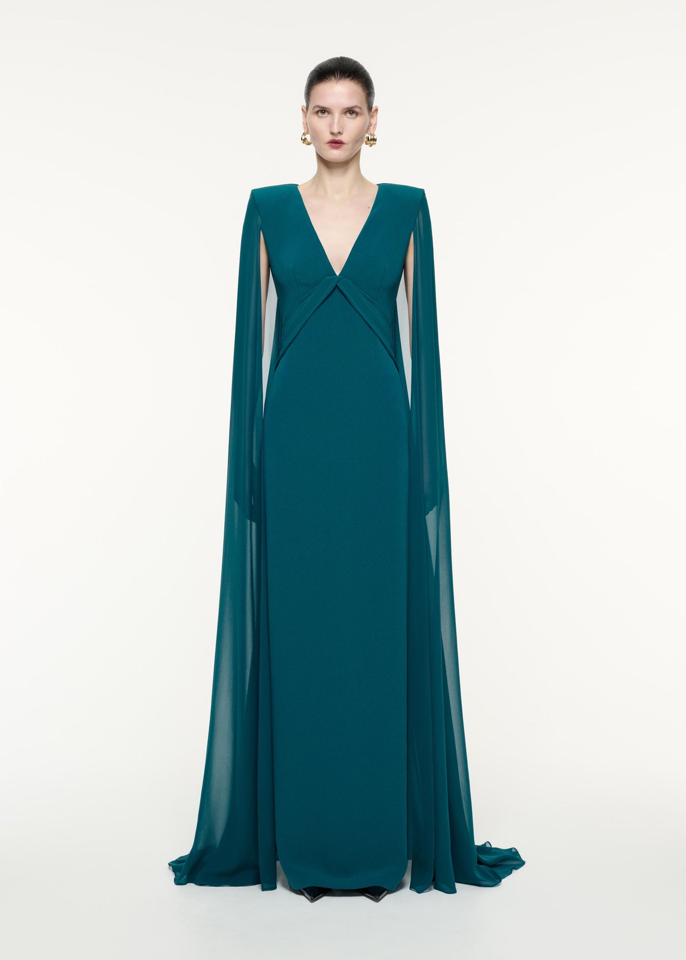 A front view image of a model wearing the Cape Sleeve Satin Crepe Gown in Green