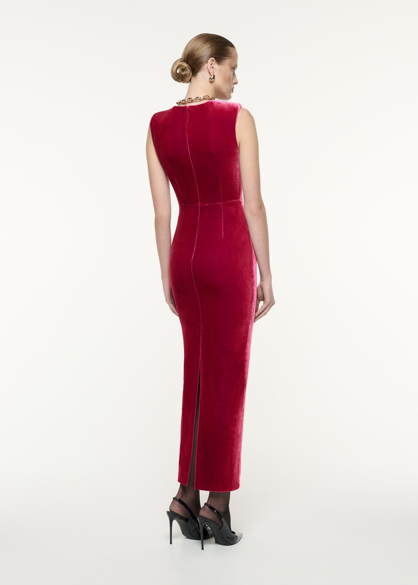 A back view image of a model wearing the Velvet Bow Maxi Dress in Pink