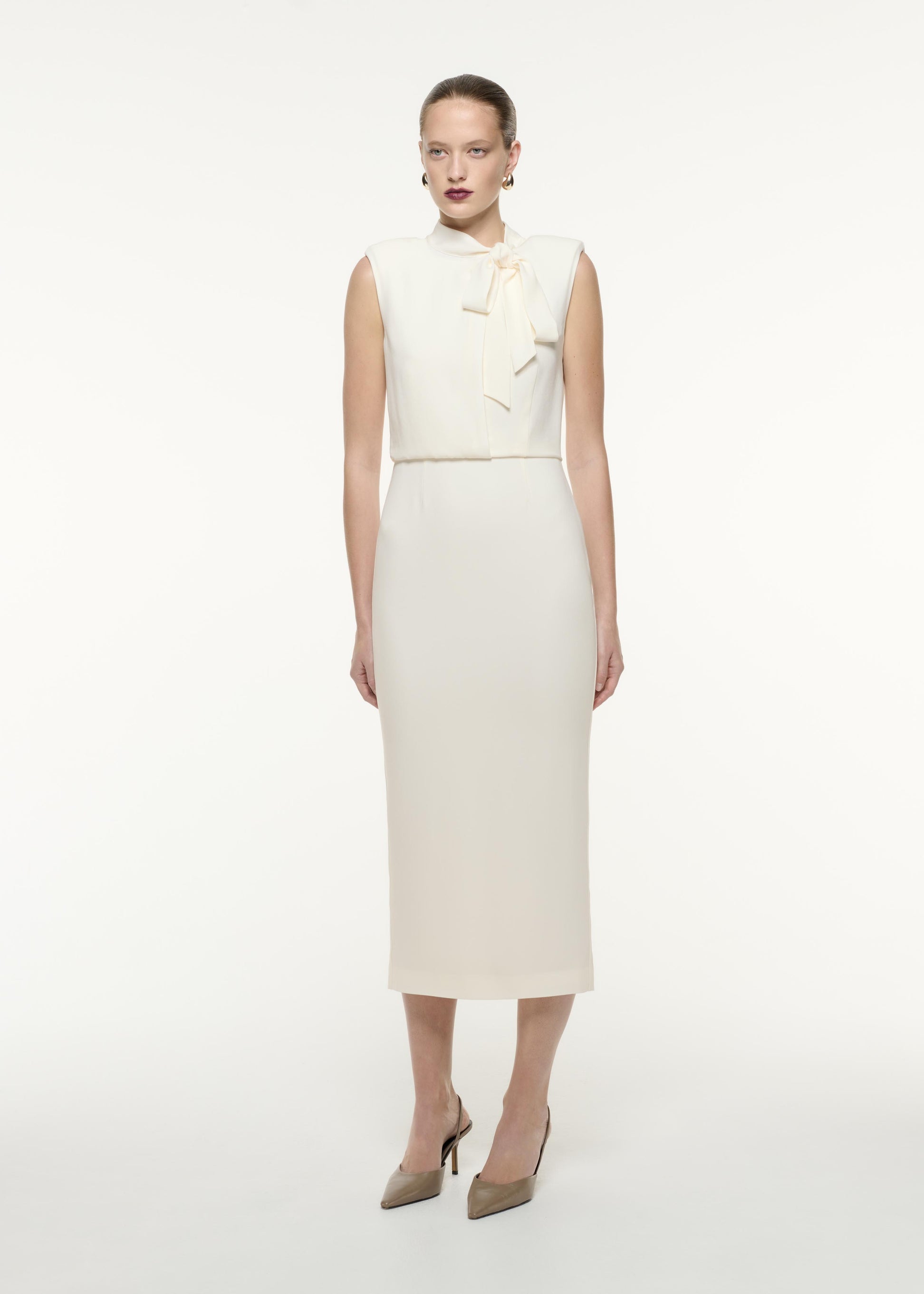 A side view image of a model wearing the Satin Crepe Midi Dress in Cream