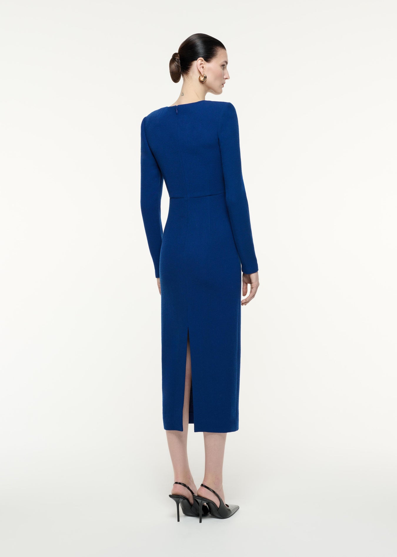A back view image of a model wearing the Long Sleeve Wool Crepe Midi Dress in Navy