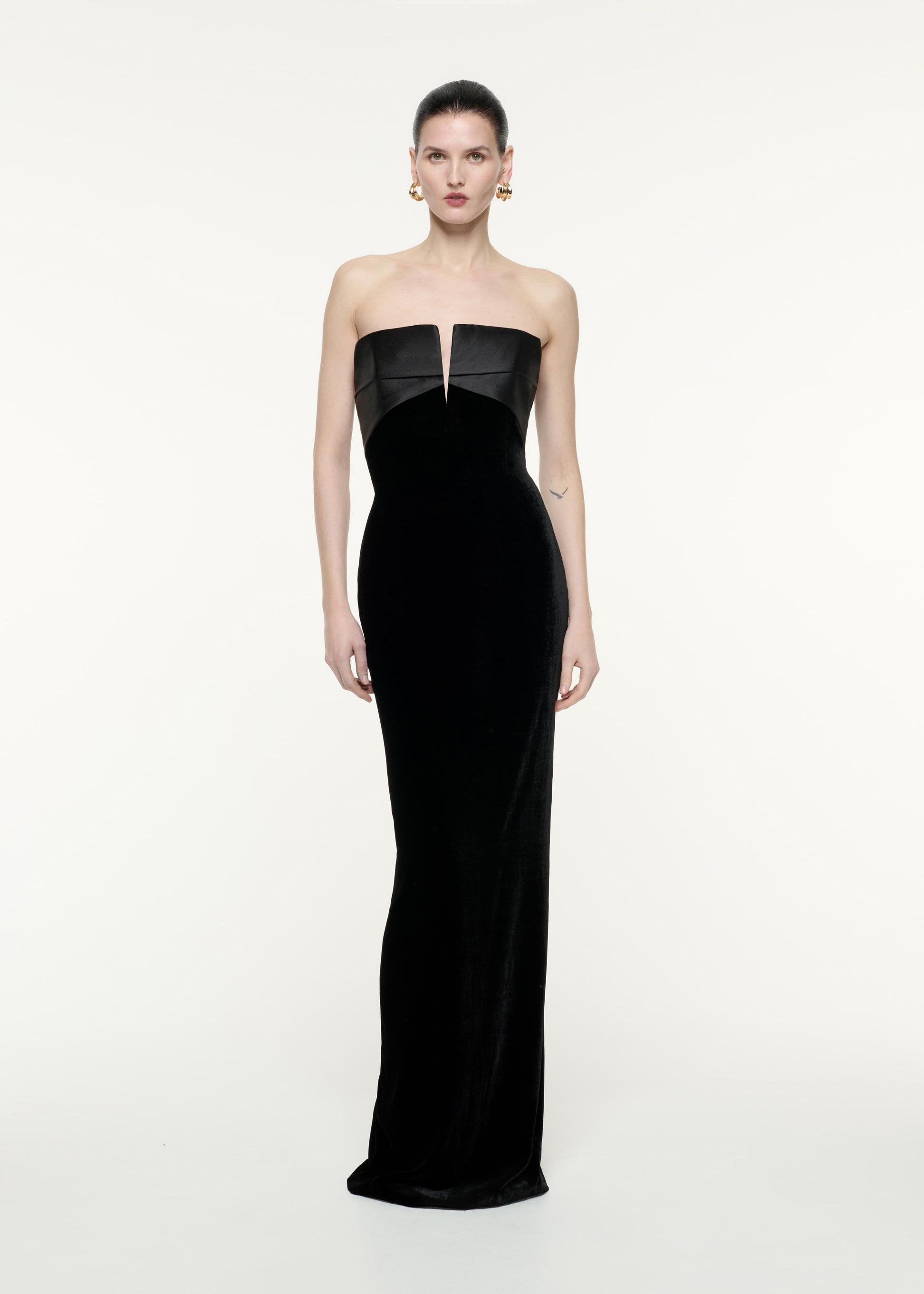 A front view image of a model wearing the Strapless Velvet Gown in Black