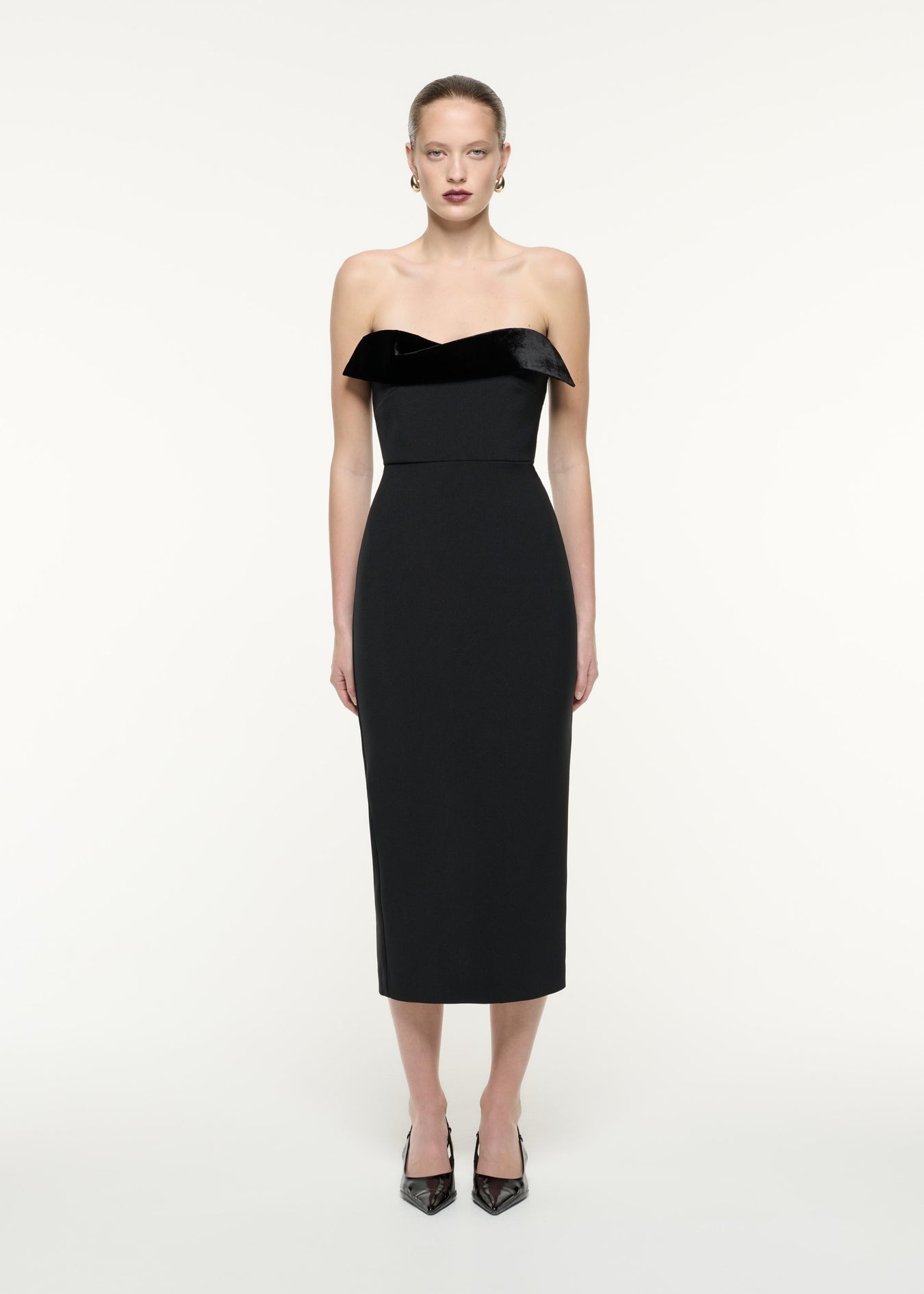 A front view image of a model wearing the Strapless Crepe Midi Dress in Black