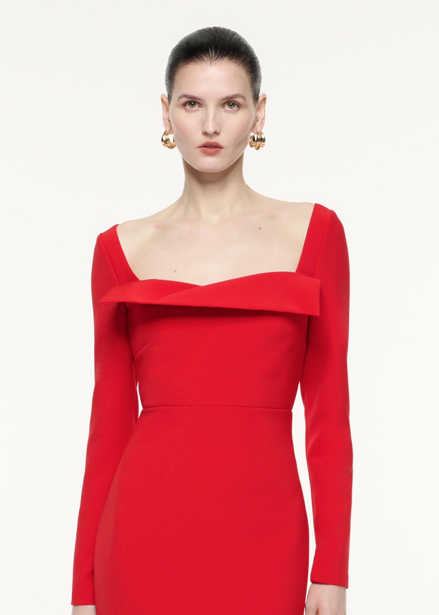 A close up image of a model wearing the Long Sleeve Crepe Midi Dress in Red