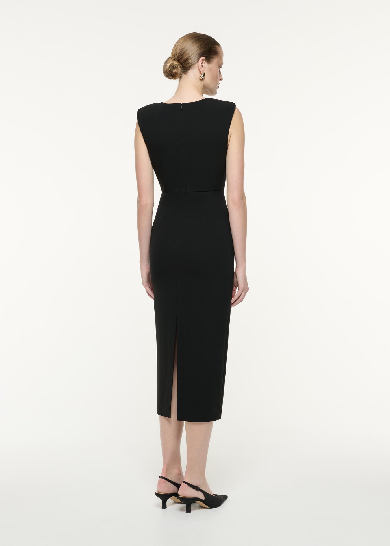 A back view image of a model wearing the Heavy Cady Ruffle Midi Dress in Monochrome