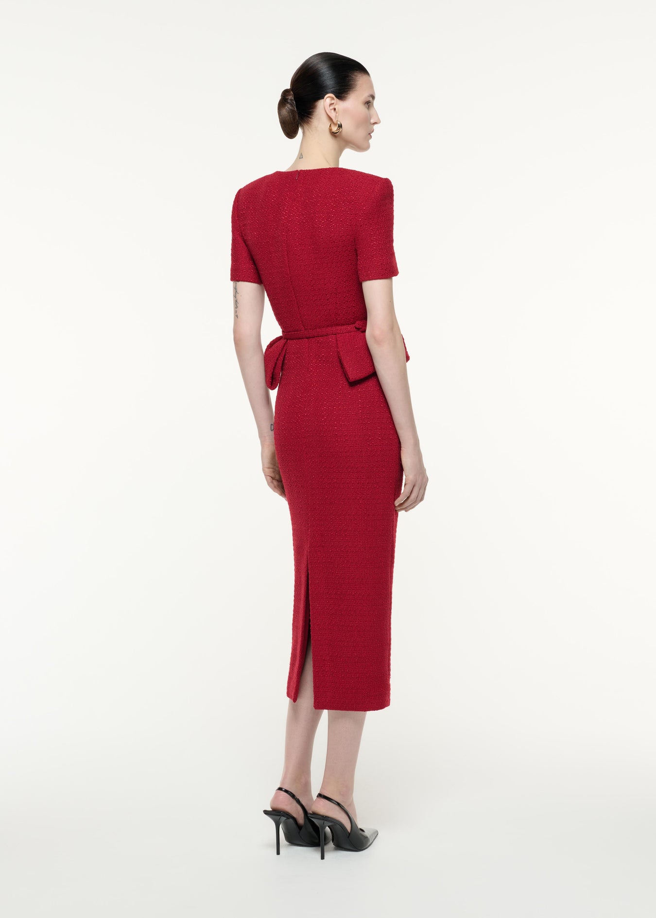 A back view image of a model wearing the Short Sleeve Boucle Midi Dress in Red