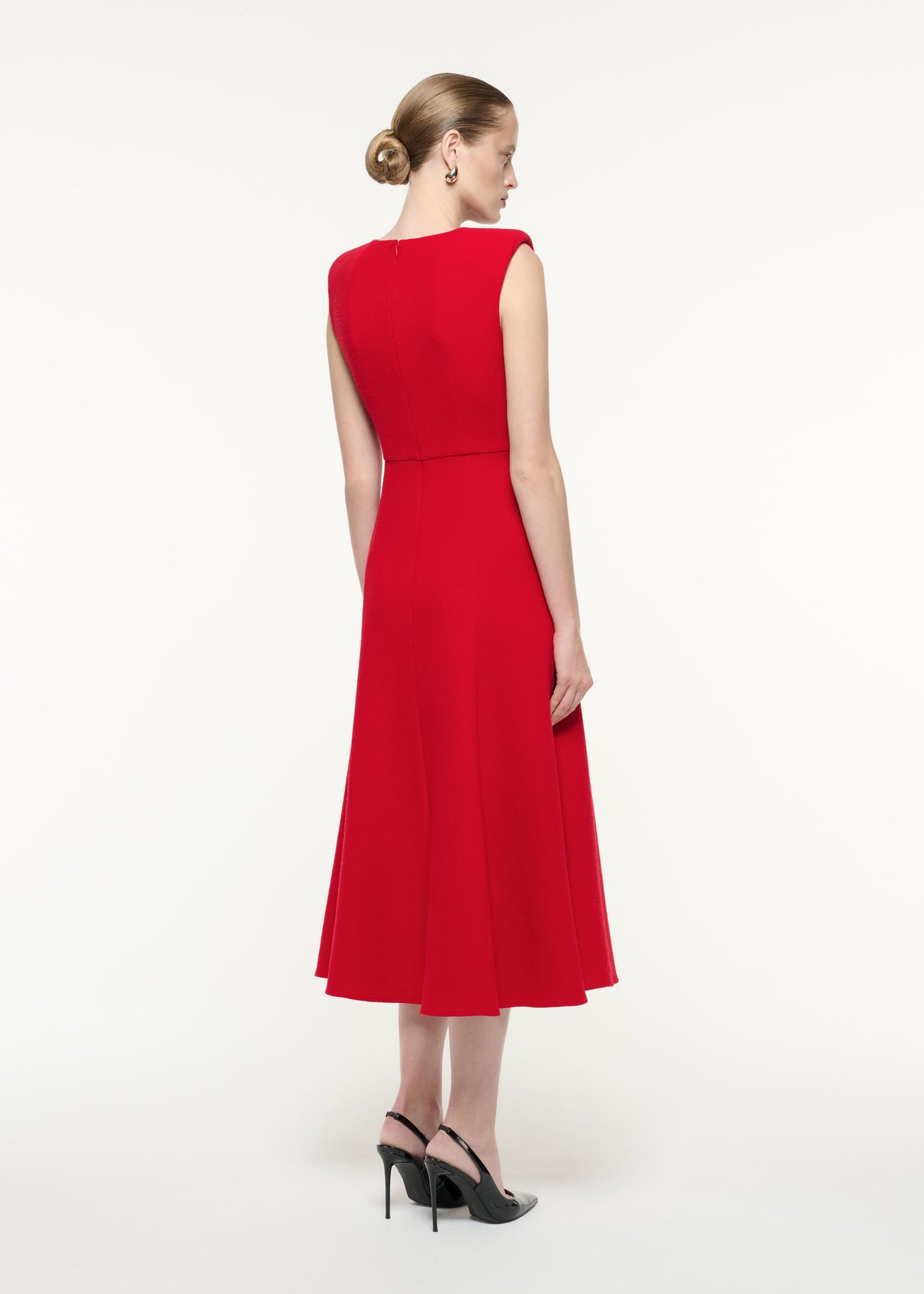 A back view image of a model wearing the Wool Crepe Midi Dress in Red