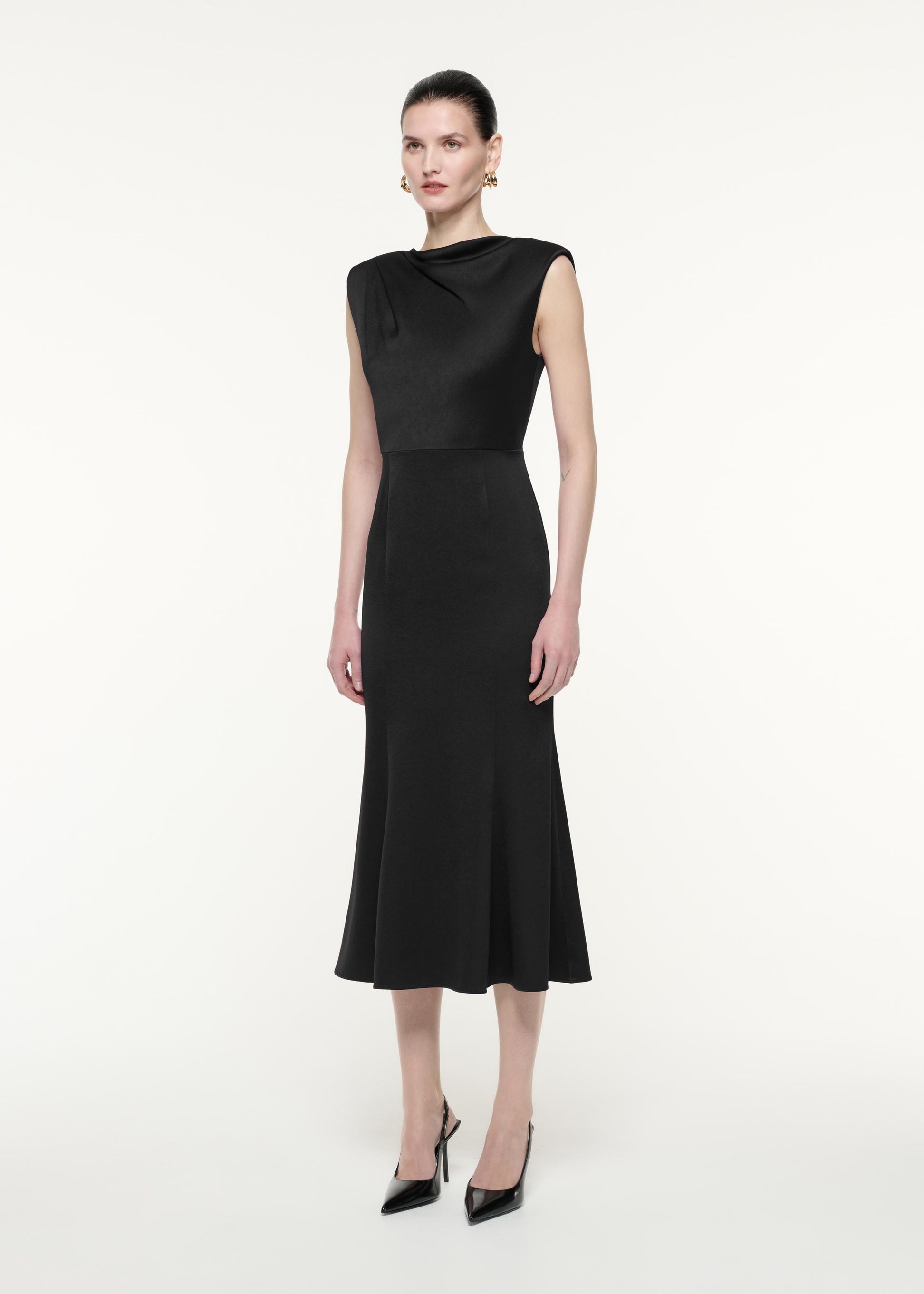 A side view image of a model wearing the Satin Crepe Midi Dress in Black