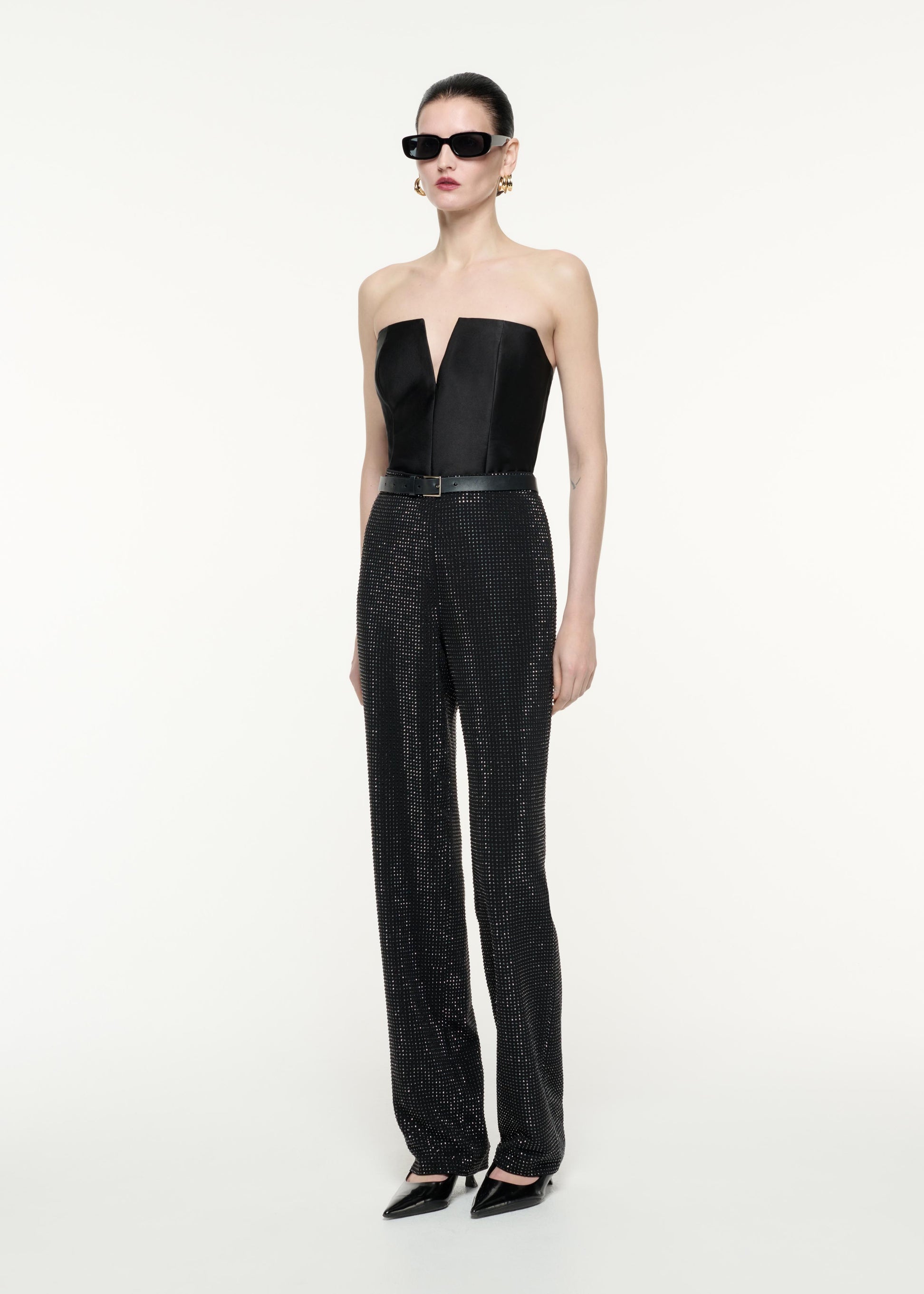 A side view image of a model wearing the Diamante Trouser in Black