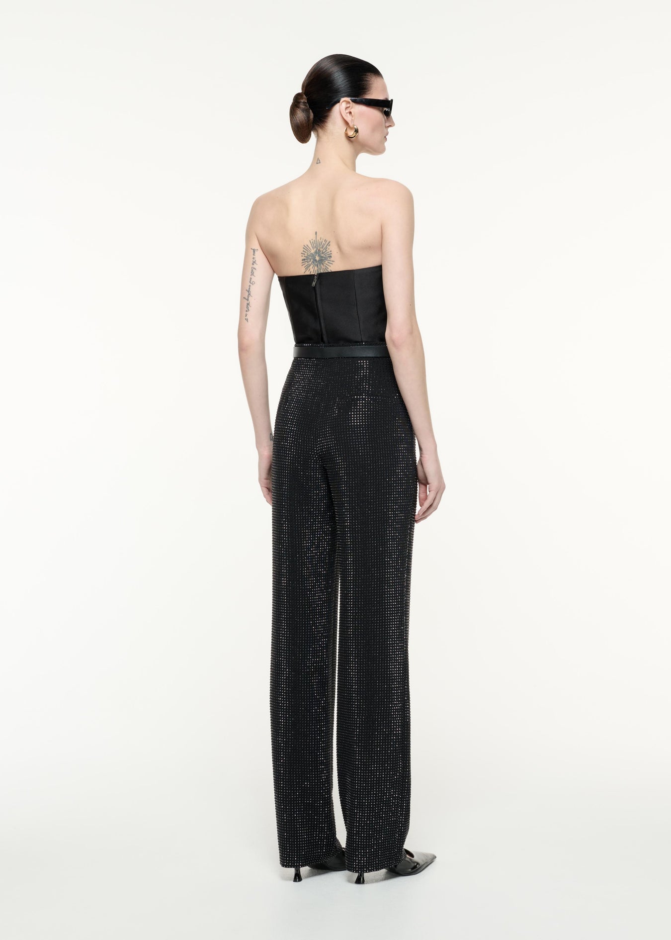 A back view image of a model wearing the Diamante Trouser in Black
