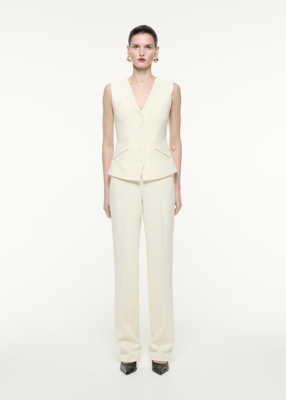 A front view image of a model wearing the Crepe Trouser in Cream