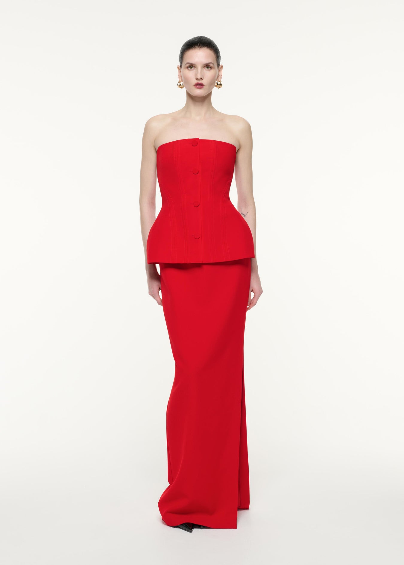 A front view image of a model wearing the Strapless Crepe Gown in Red