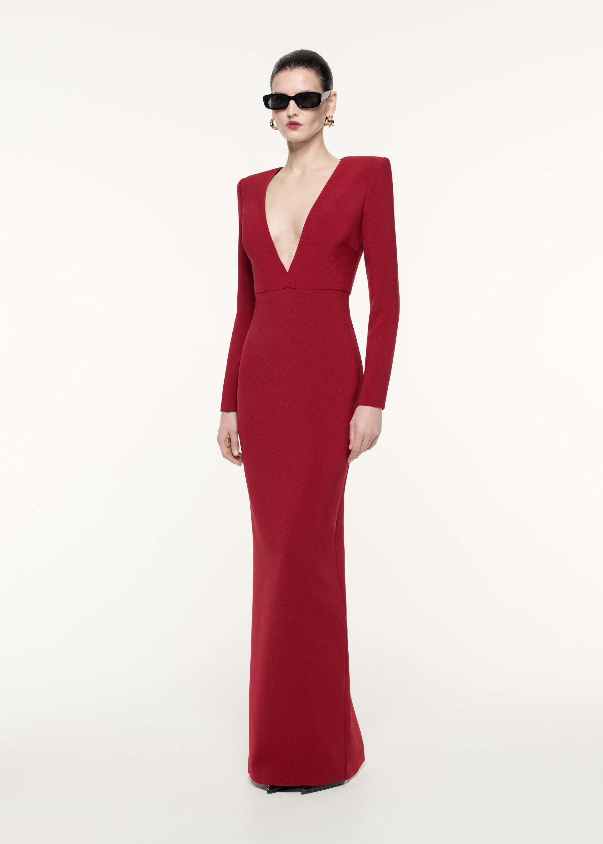 A side view image of a model wearing the Long Sleeve Crepe Maxi Dress in Red