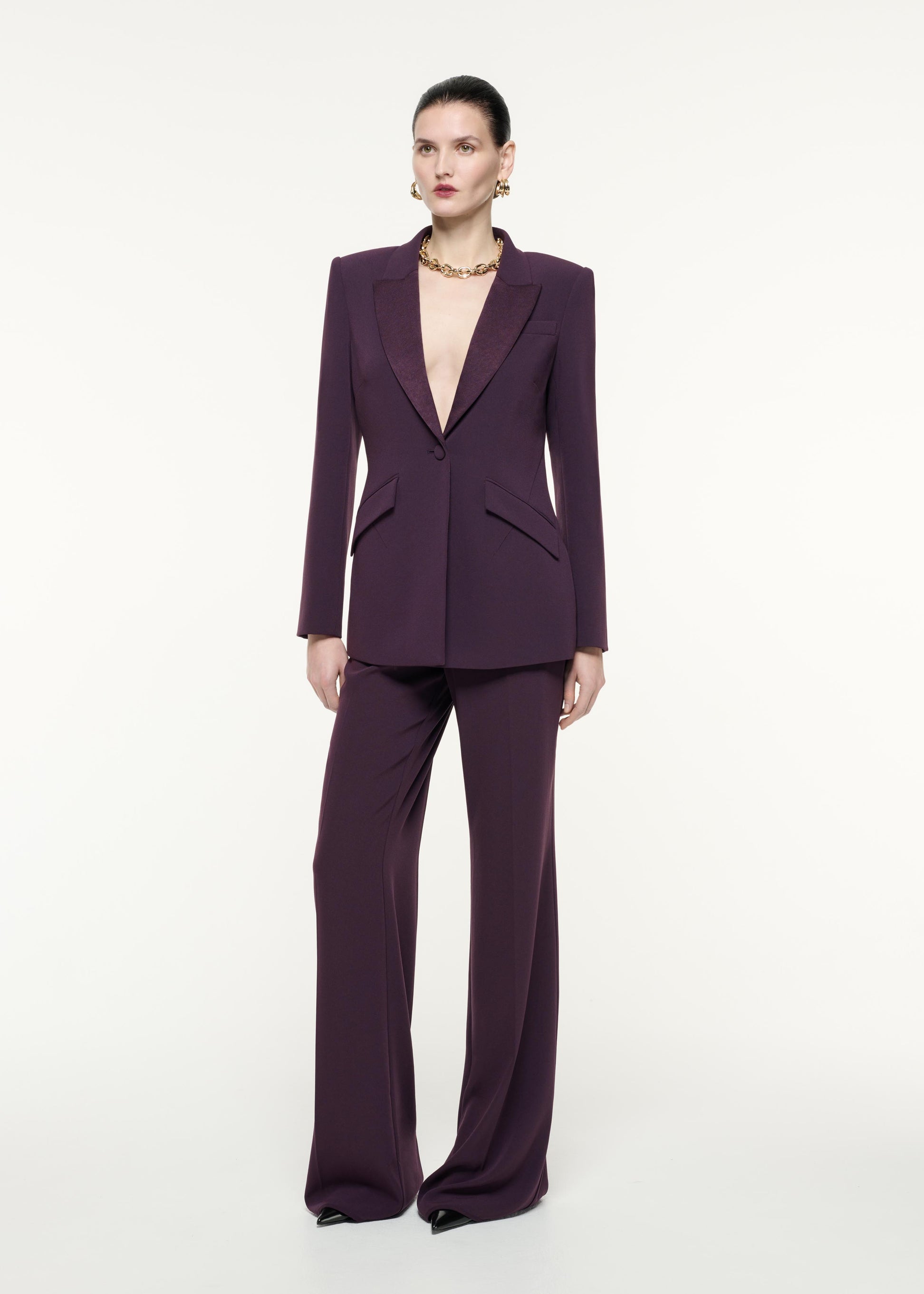 A side view image of a model wearing the Satin Crepe Jacket in Aubergine