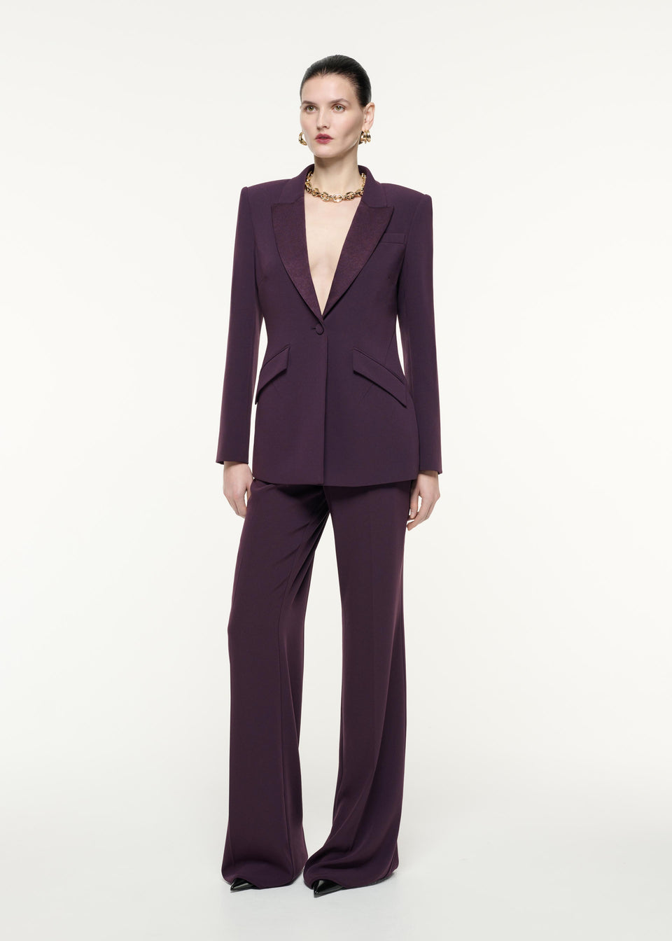 A front view image of a model wearing the Satin Crepe Trouser in Aubergine