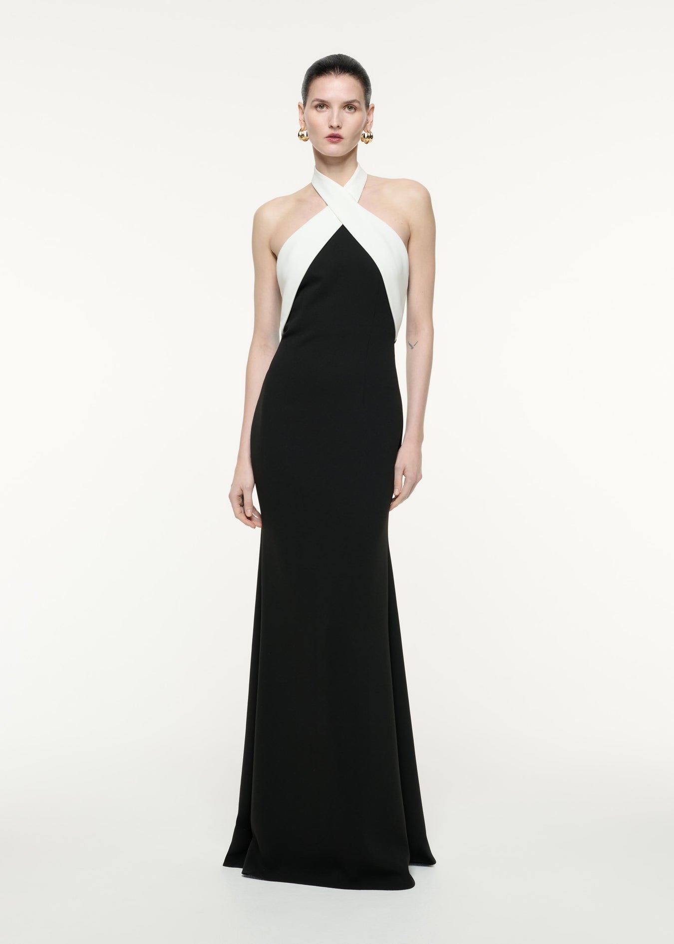 A front view image of a model wearing the Halter Neck Gown in Monochrome