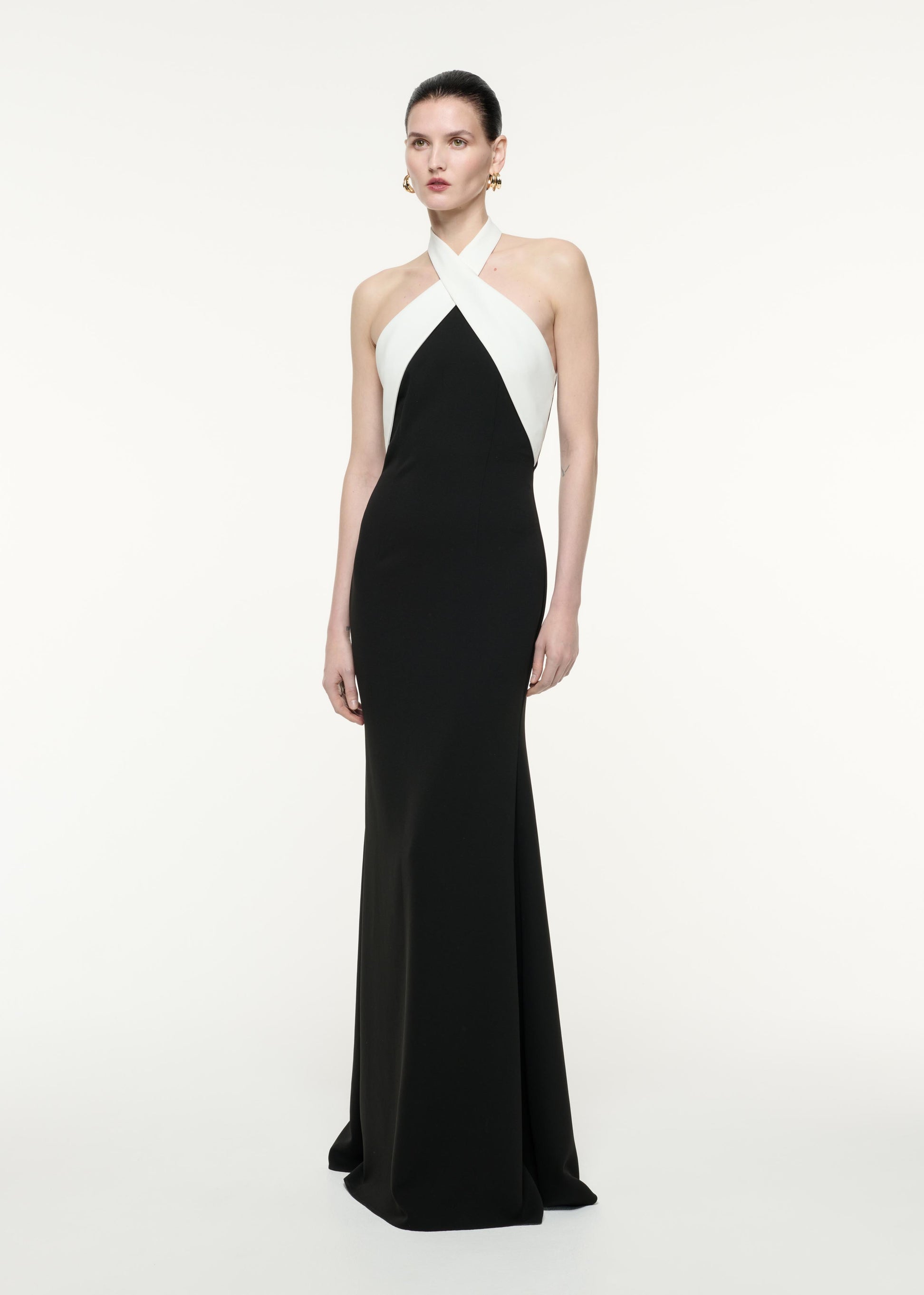 A side view image of a model wearing the Halter Neck Gown in Monochrome