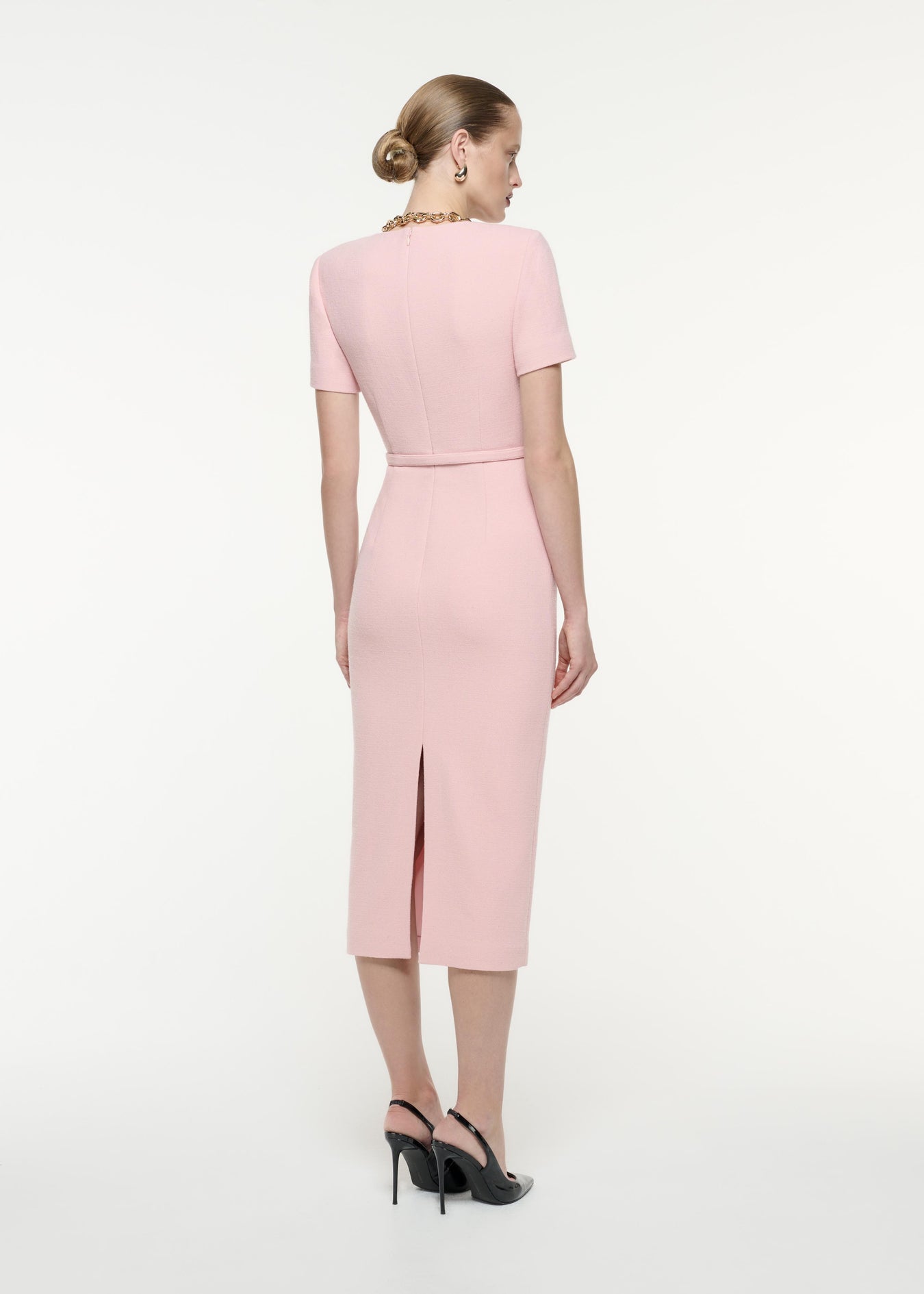 A back view image of a model wearing the Short Sleeve Wool Crepe Midi Dress in Pink