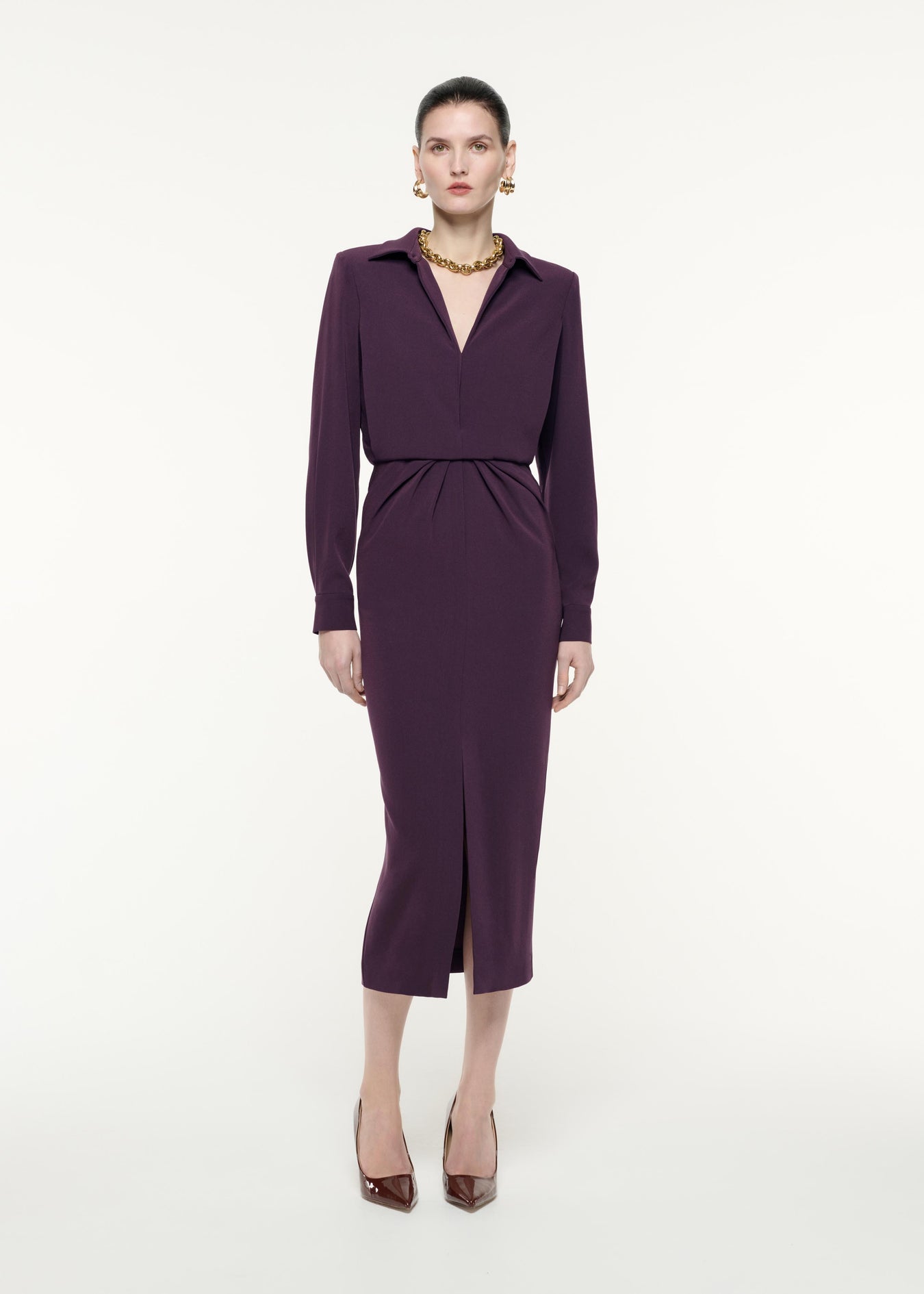 A front view image of a model wearing the Long Sleeve Satin Crepe Midi Dress in Aubergine