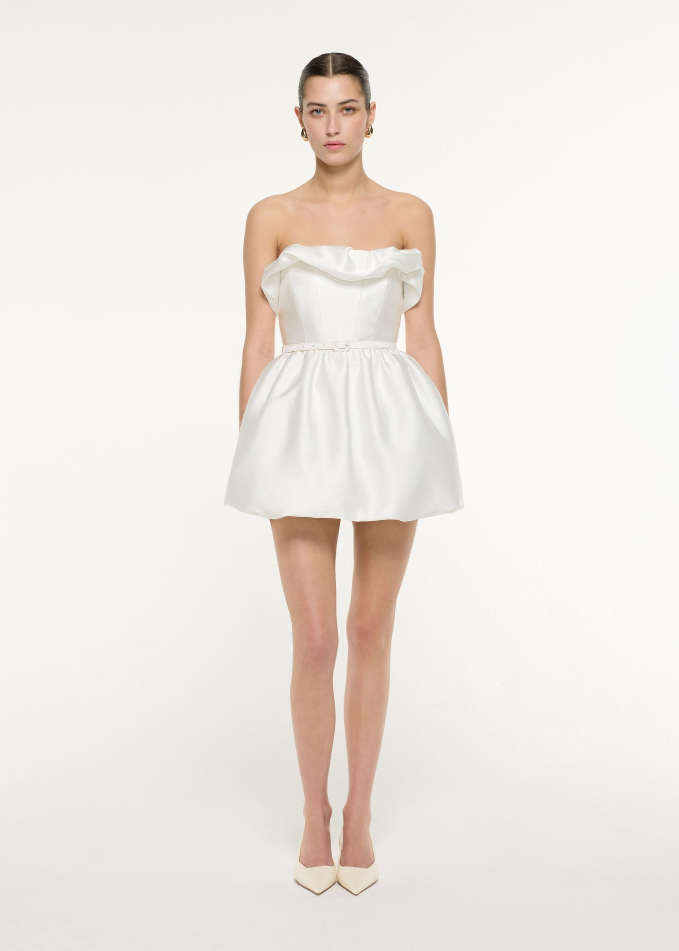 Front view of a model wearing the Ruffle Mini Dress in White