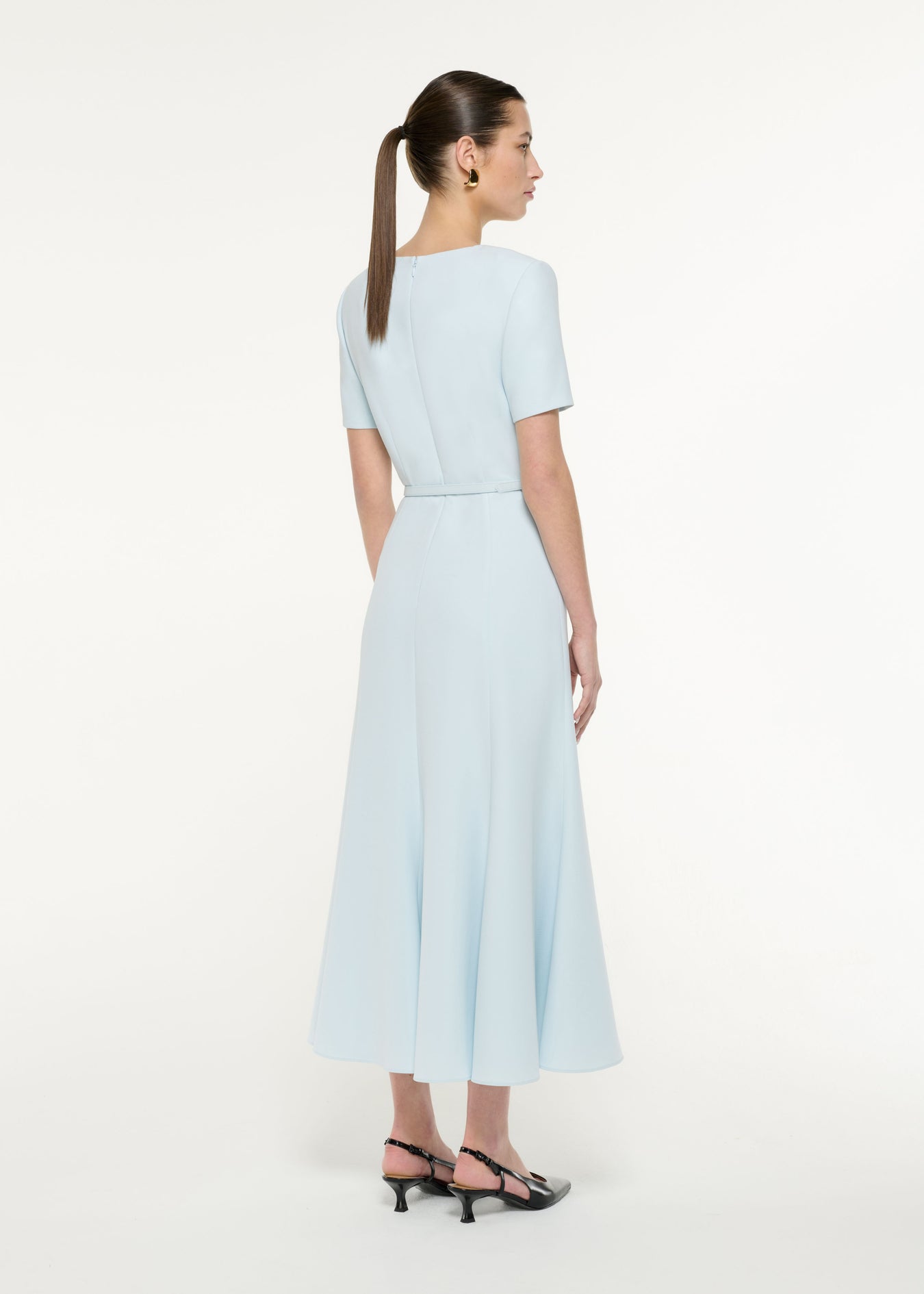 Back view of a model wearing the Tri-fold Belted Midi Dress in Blue