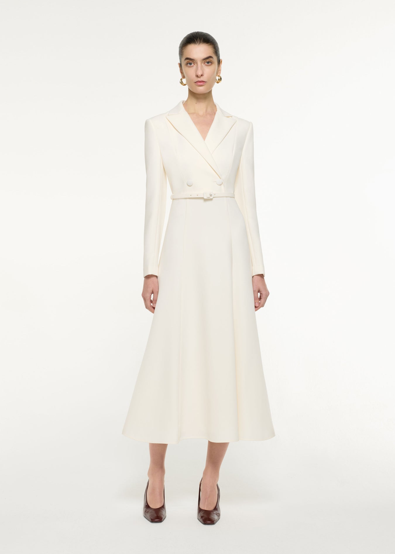 Front view of a model wearing the Tailored Midi Dress in Cream