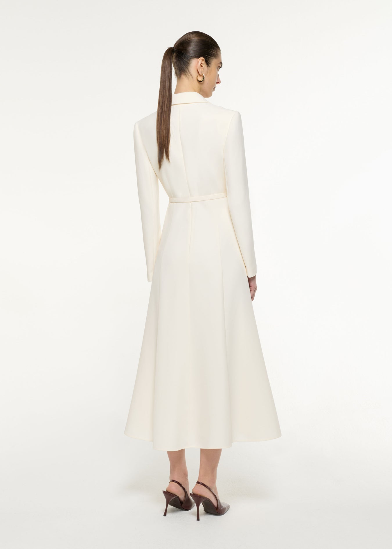 Back view of a model wearing the Tailored Midi Dress in Cream