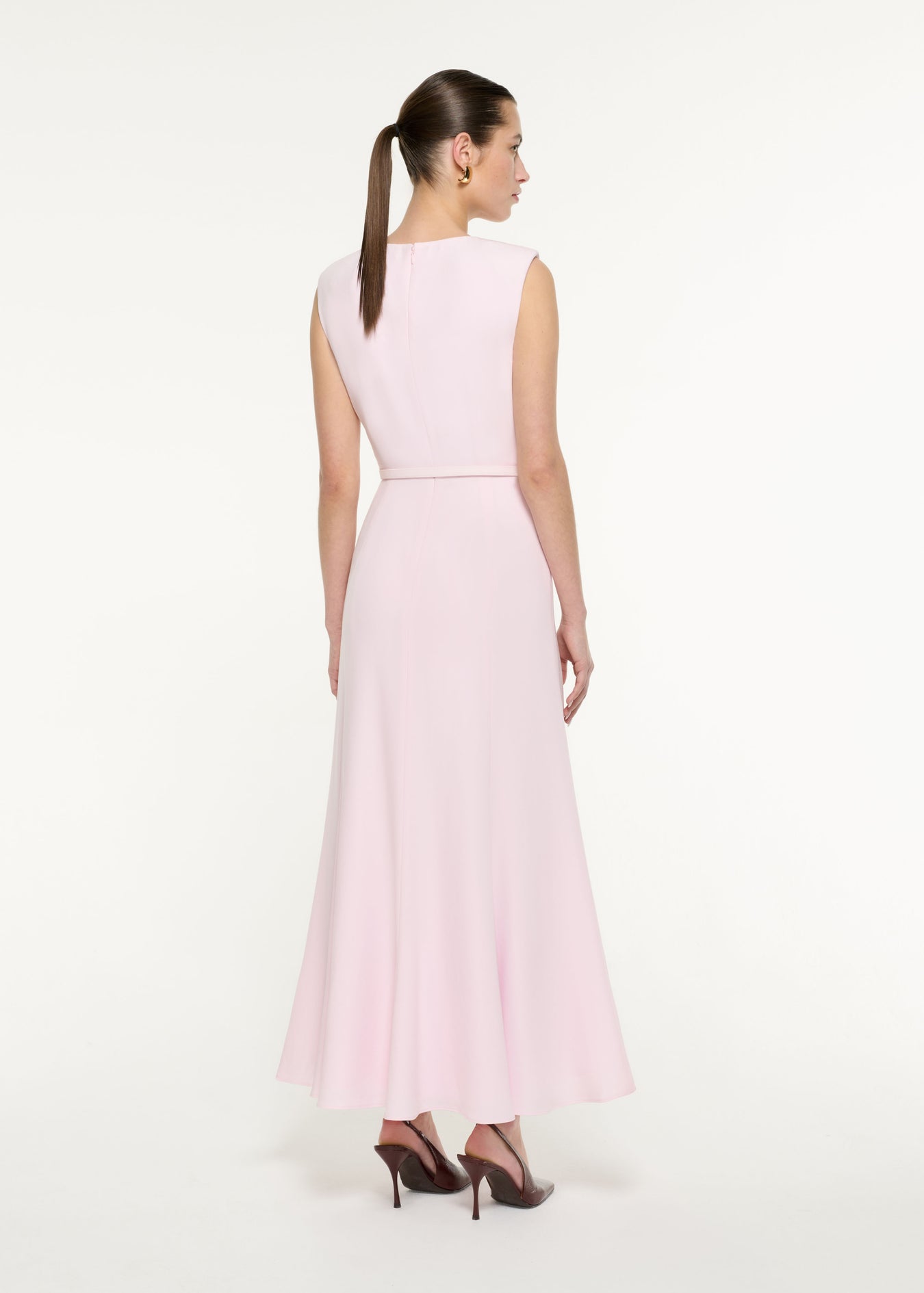 Back view of a model wearing the Bow Drape Satin Crepe Maxi Dress in Light Pink 