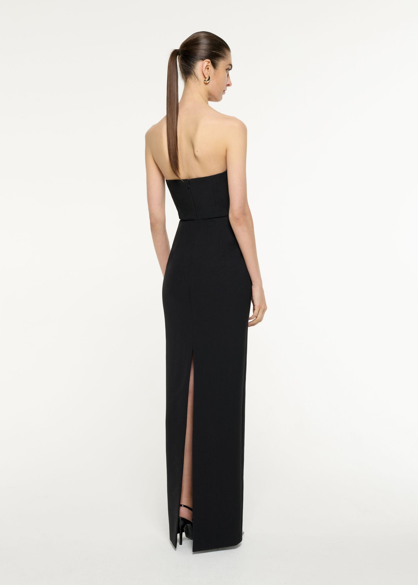 Back view of a model wearing the Diamante Panel Gown in Black