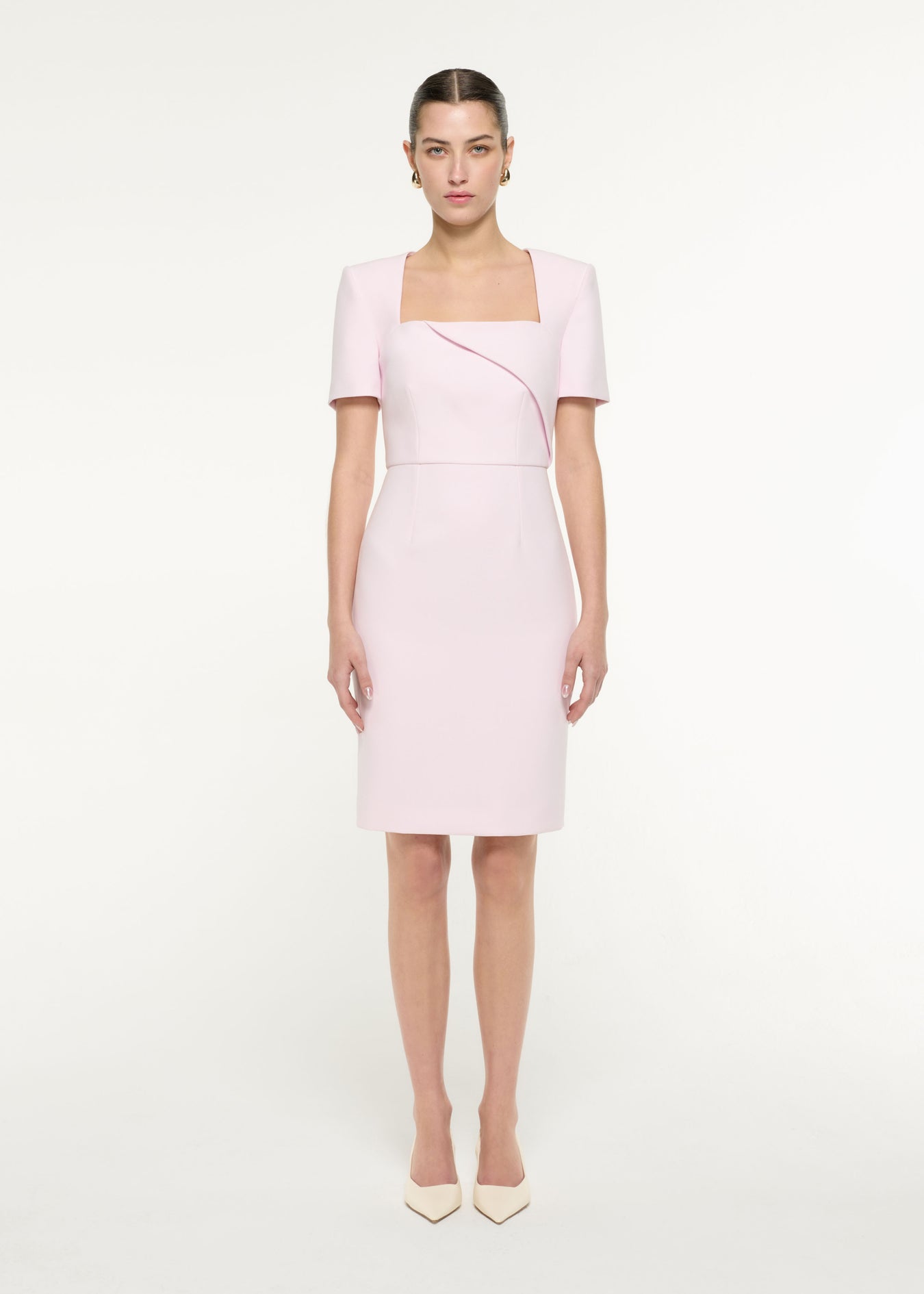 Front view of a model wearing the Diagonal Fold Midi Dress in Light Pink