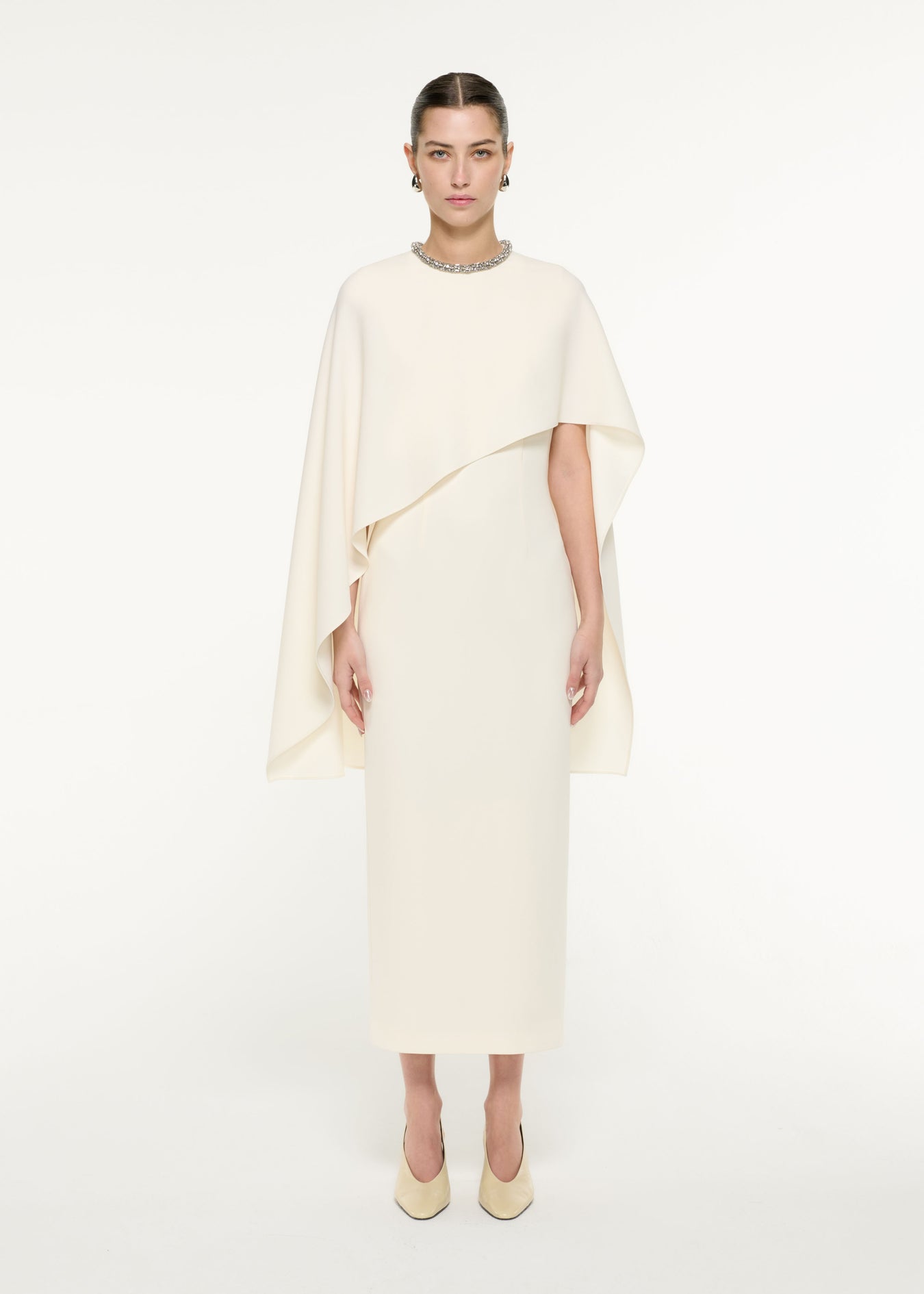 Front view of a model wearing the Heavy Cady Cape Midi Dress in Cream