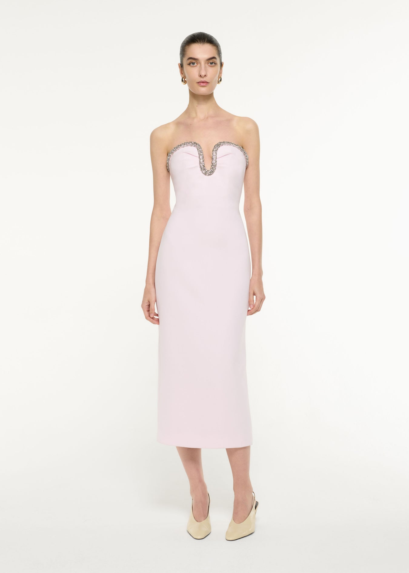 Front view of a model wearing the Sweetheart Embellished Midi Dress in light pink