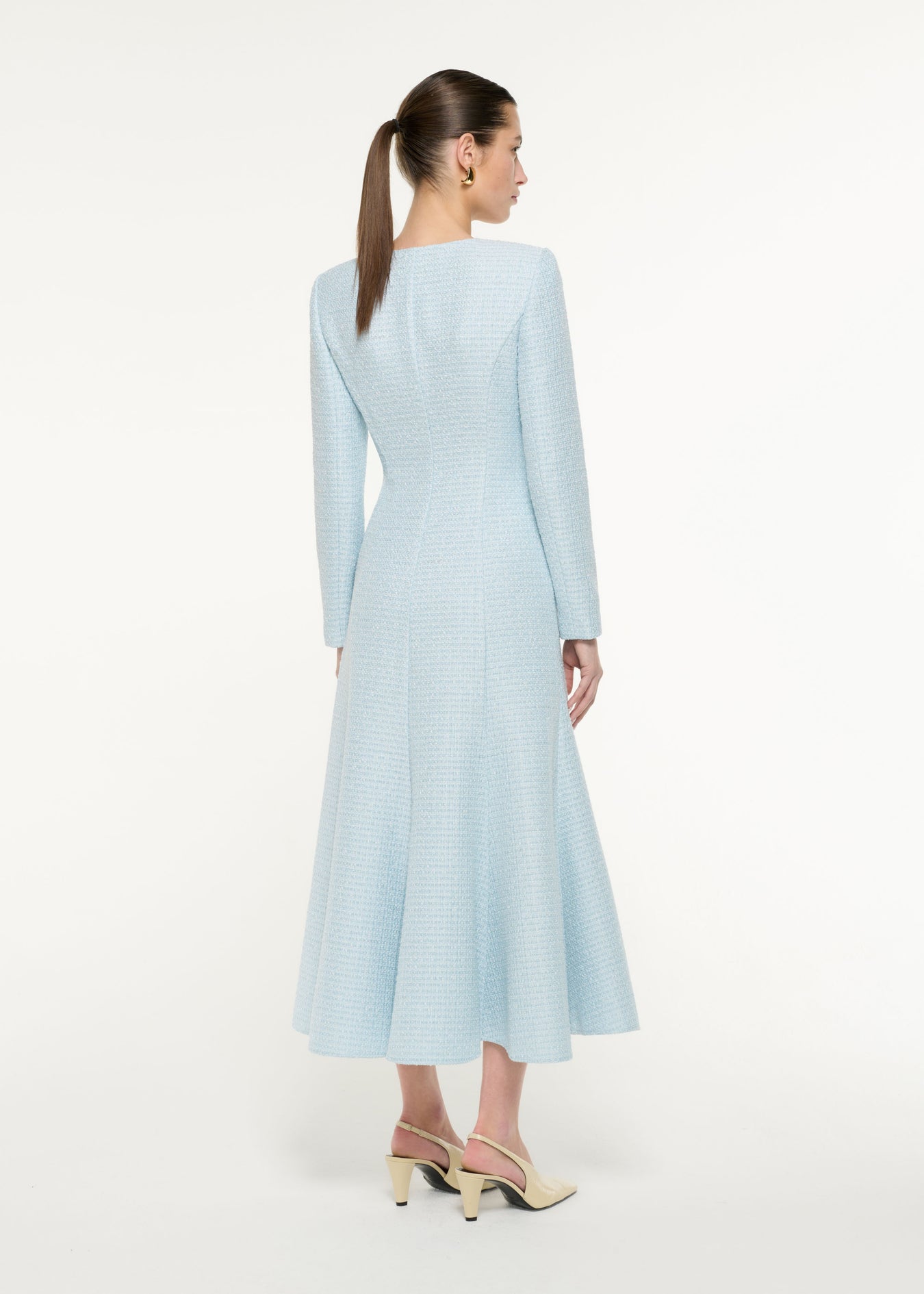 Back view of a model wearing the Boucle Midi Dress in blue