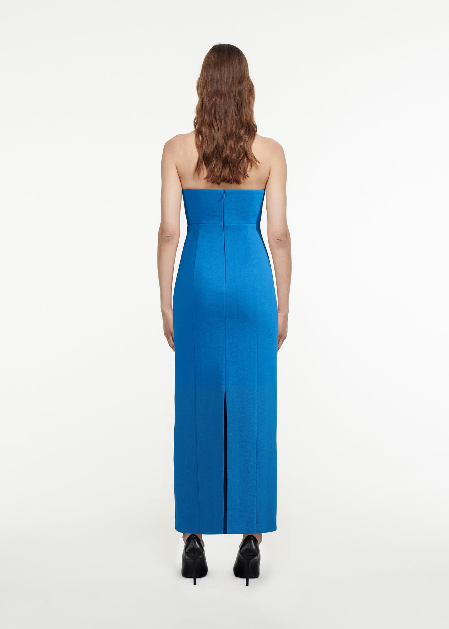 The back of a woman wearing the Strapless Wool Crepe Midi Dress in Blue