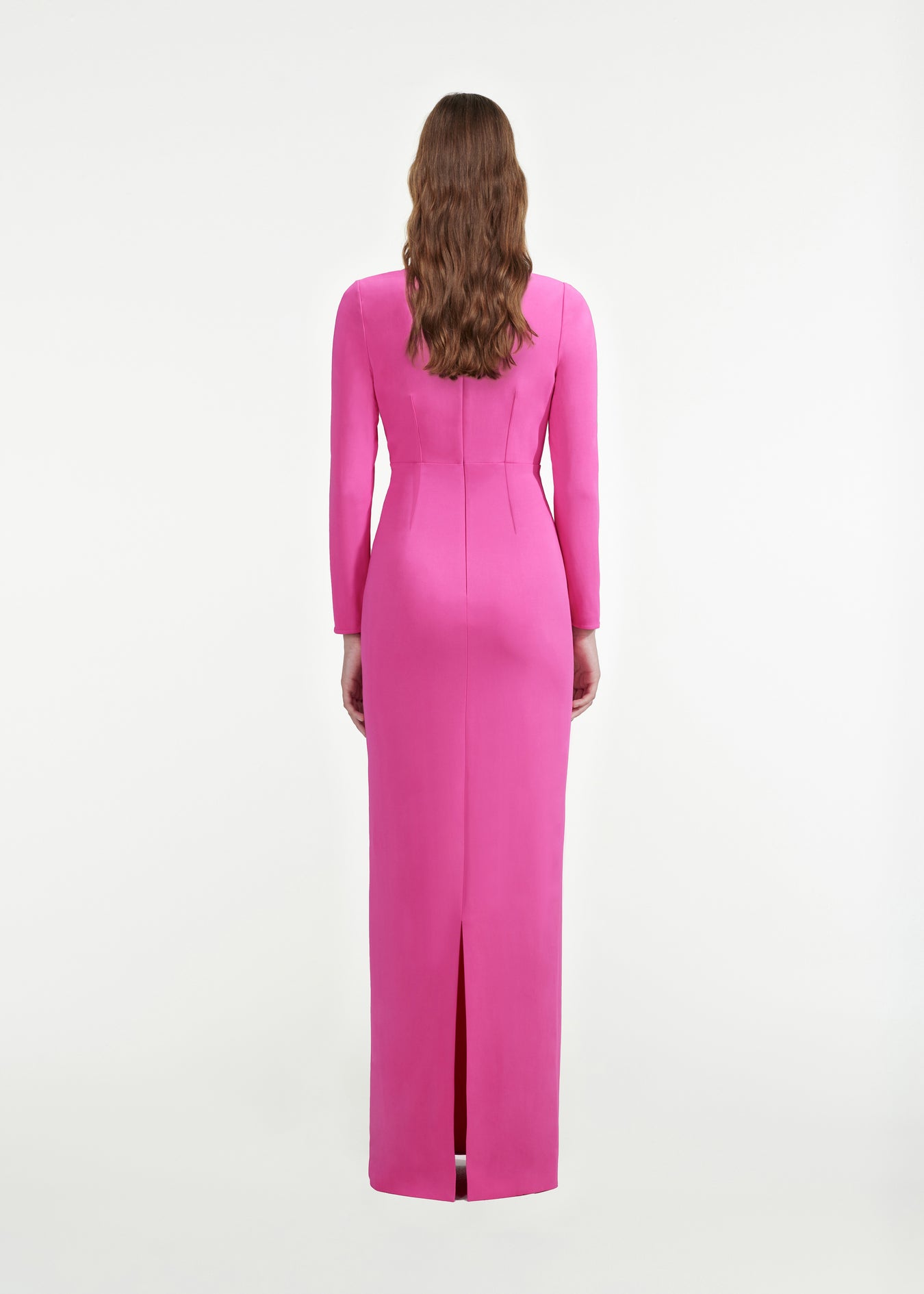 The back of a woman wearing the Long Sleeve Stretch-Cady Gown in Pink