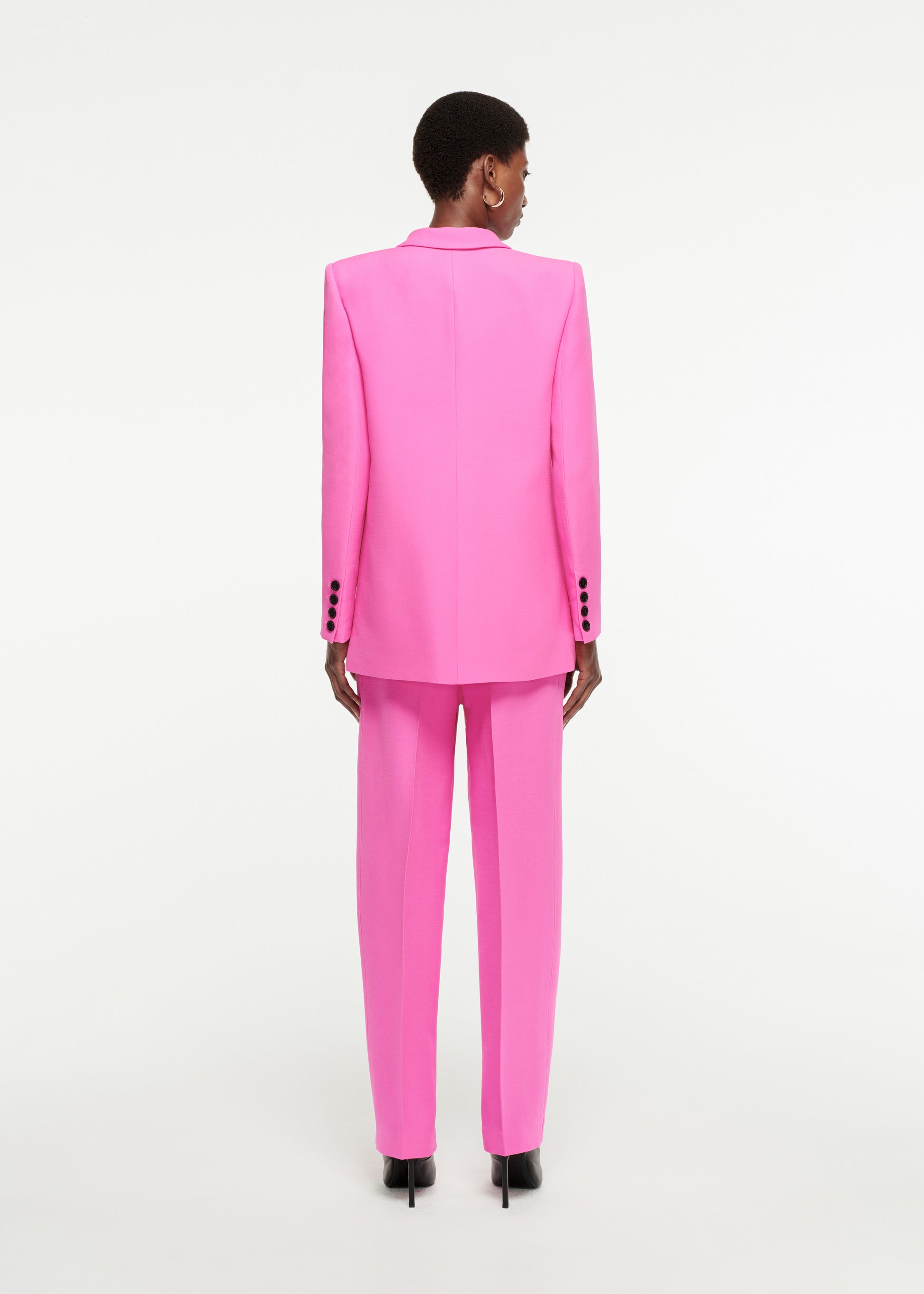 The back of a woman wearing the Straight-Cut Silk Wool Trouser in Pink 