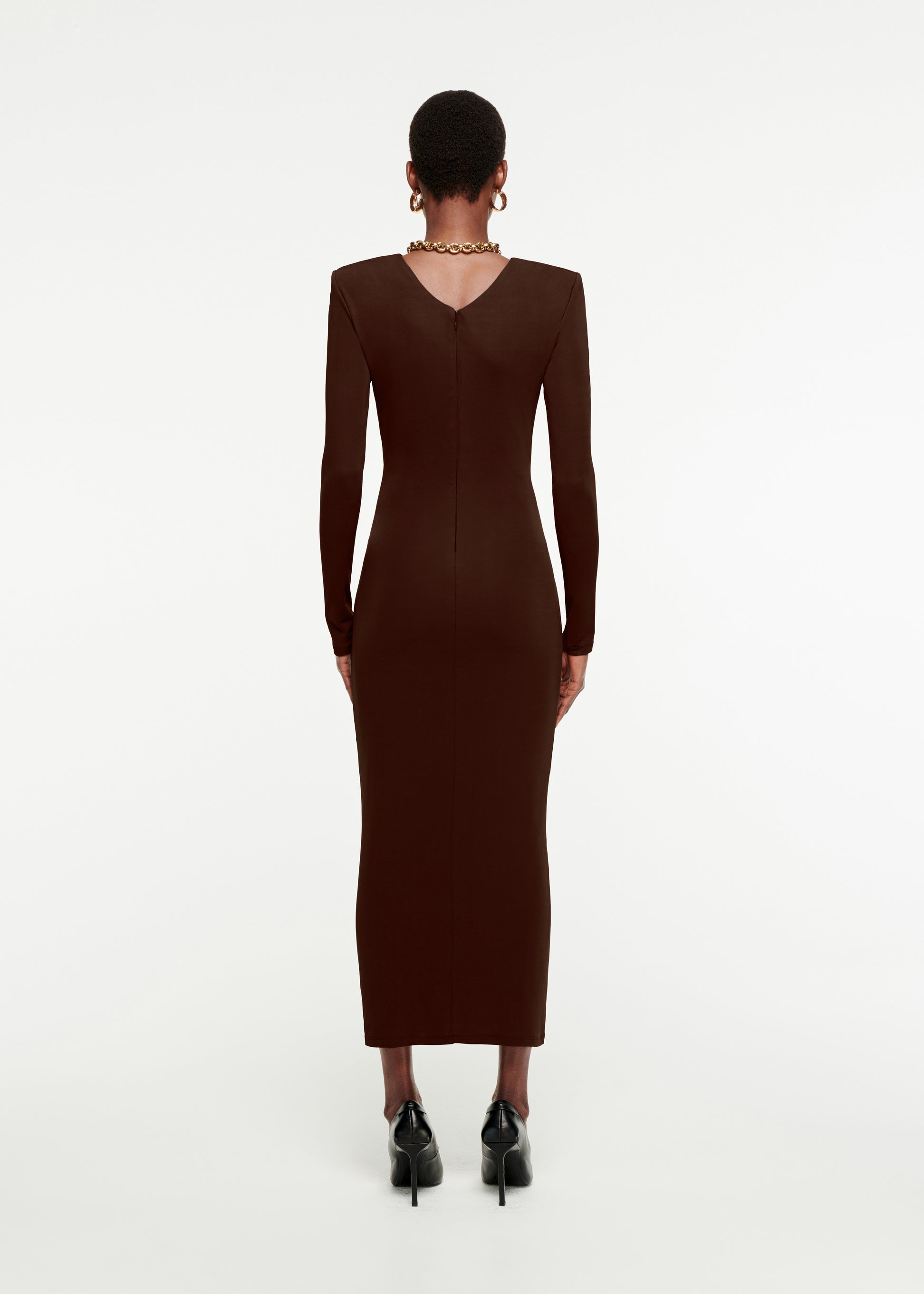 The back of a woman wearing the Long Sleeve Ruched Jersey Midi Dress in Brown