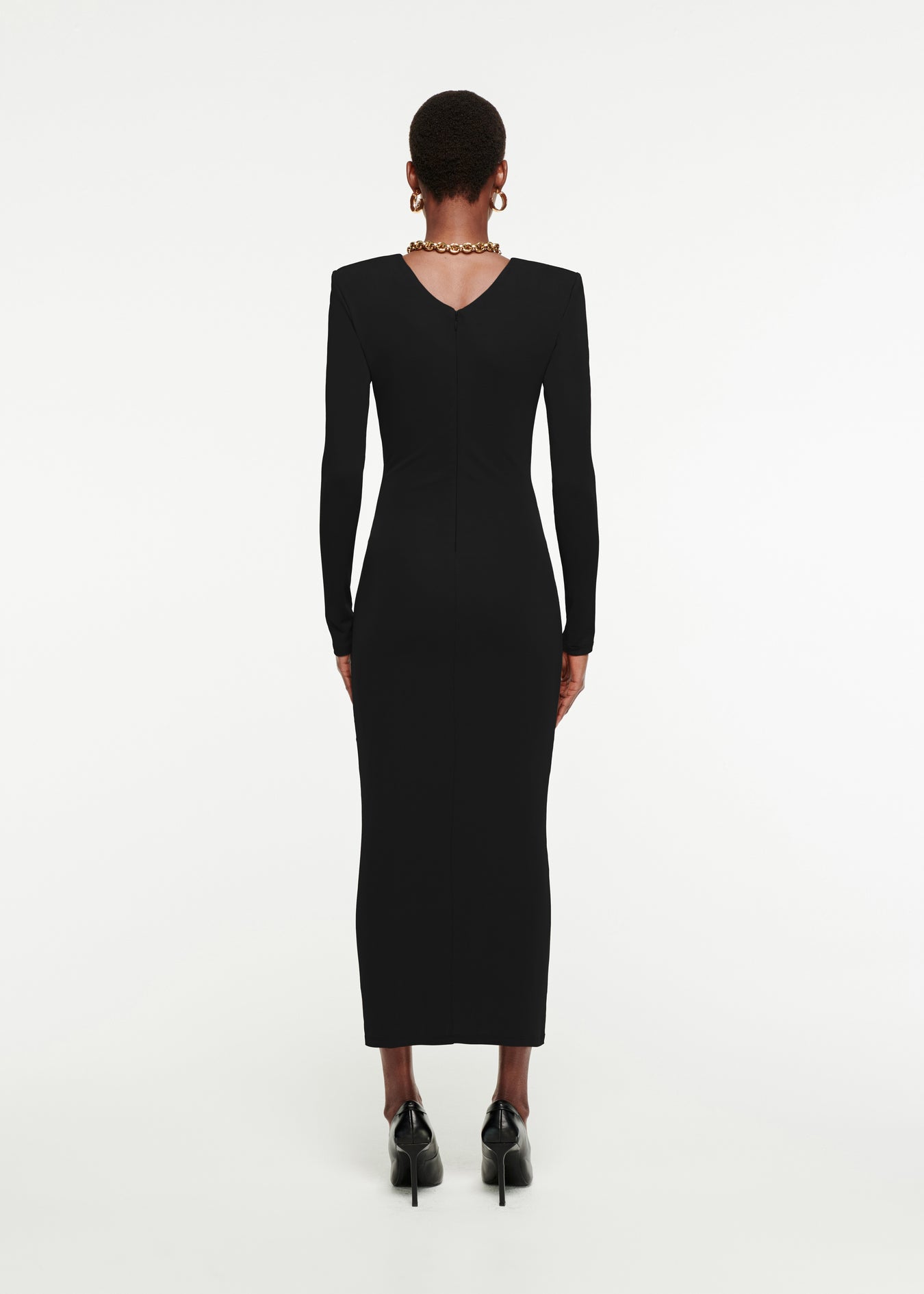 The back of a woman wearing the Long Sleeve Ruched Jersey Midi Dress in Black 