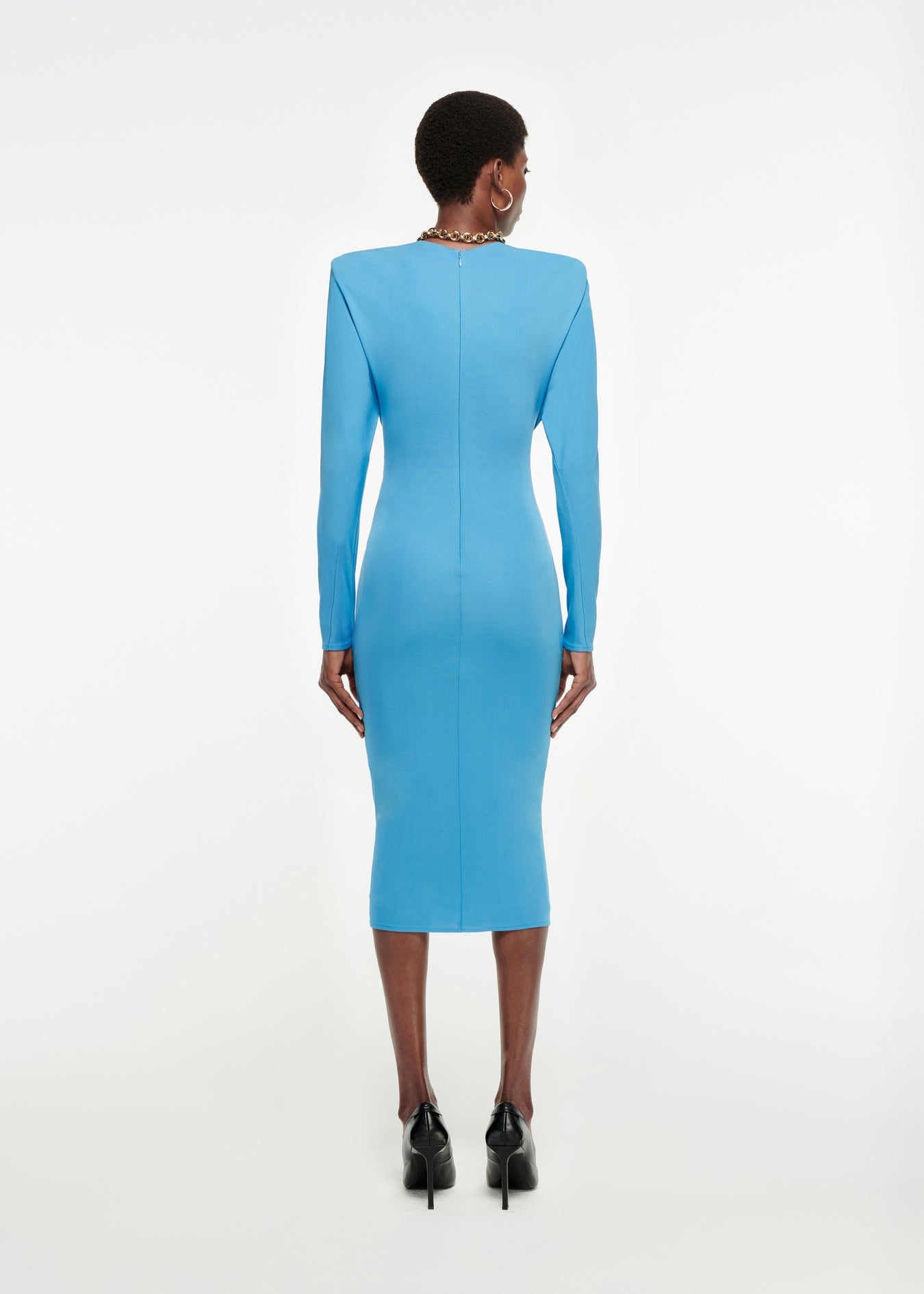 The back of a woman wearing the Long Sleeve Twisted Jersey Midi Dress in Blue