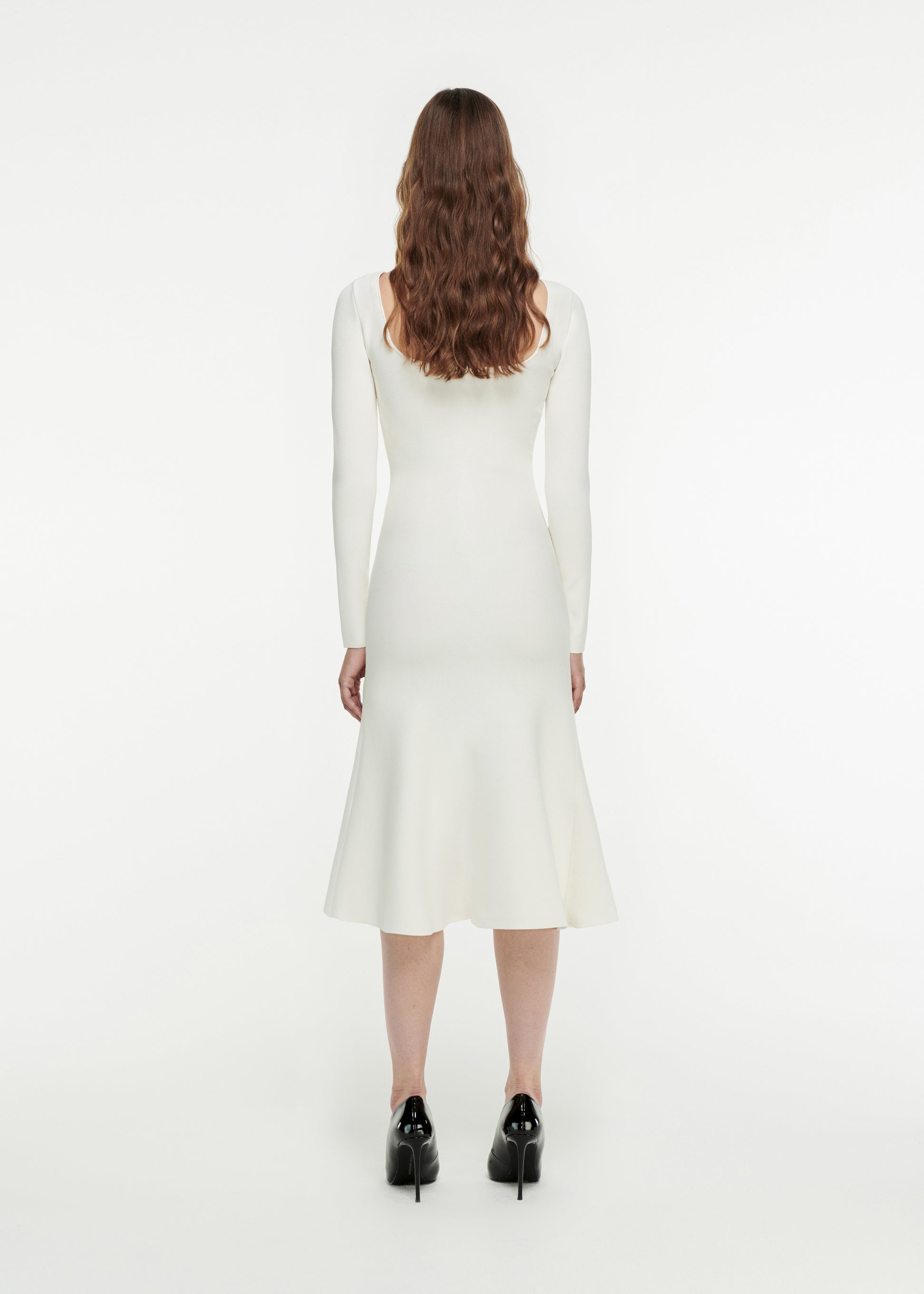 The back of a woman wearing the Long Sleeve Knit Dress in White 