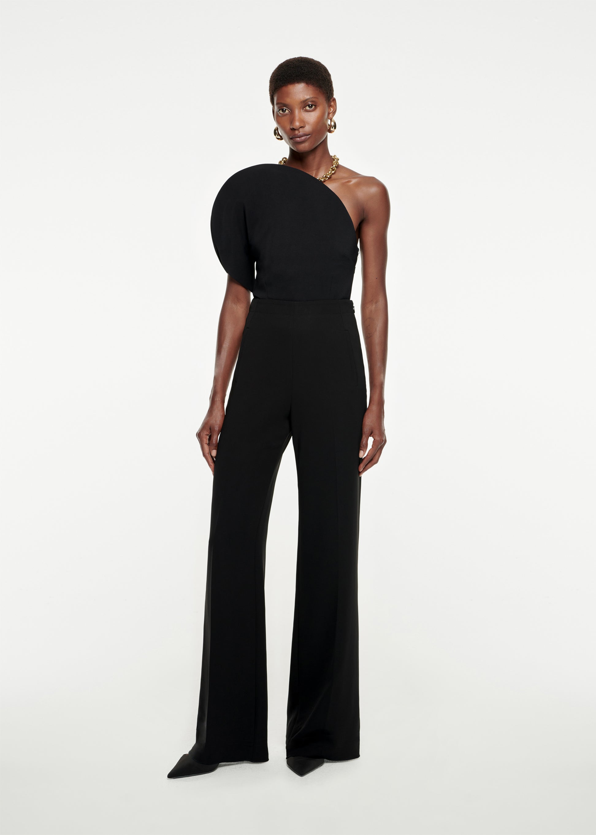 Woman wearing the Asymmetric Stretch-Cady Jumpsuit in Black